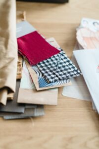 Textile samples and paper illustrations on a table 