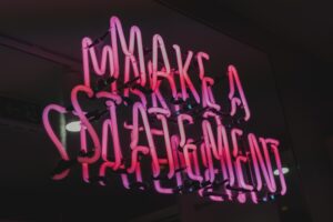 A neon sign reading "Make a Statement"