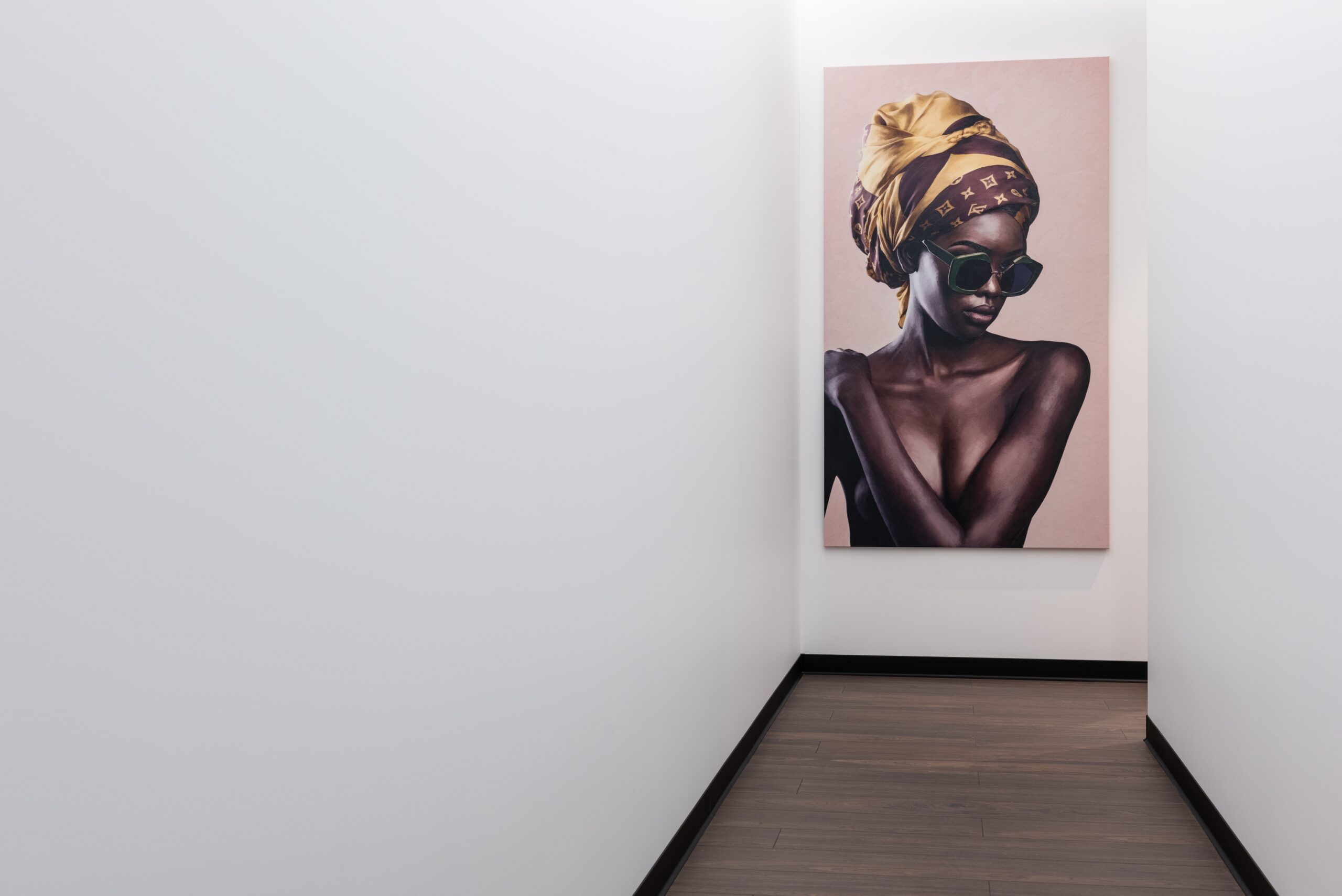 A single painting of a Black woman hanging in a hallway
