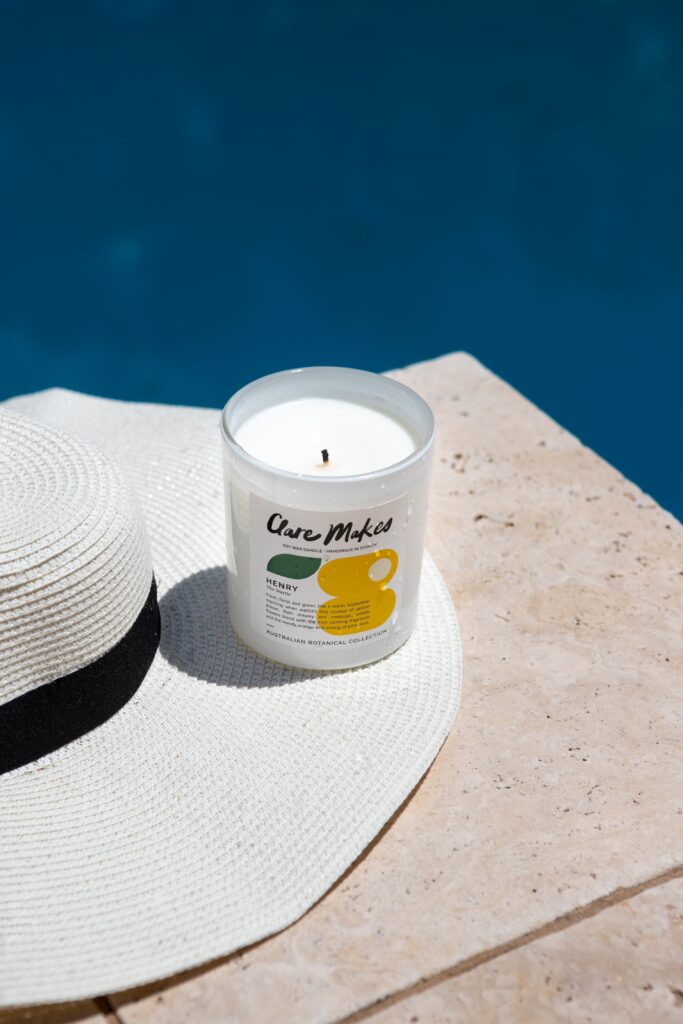 candle and a hat by the pool