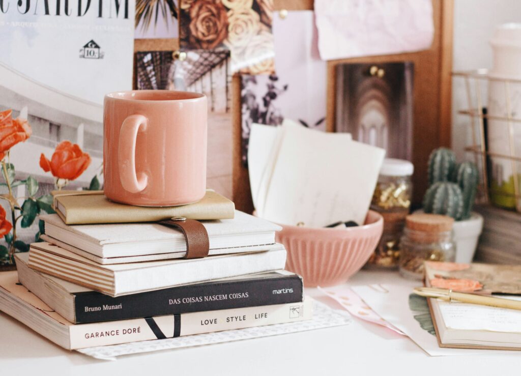 Black-Owned Stationery Brands pictured: desk with books and coffee mug