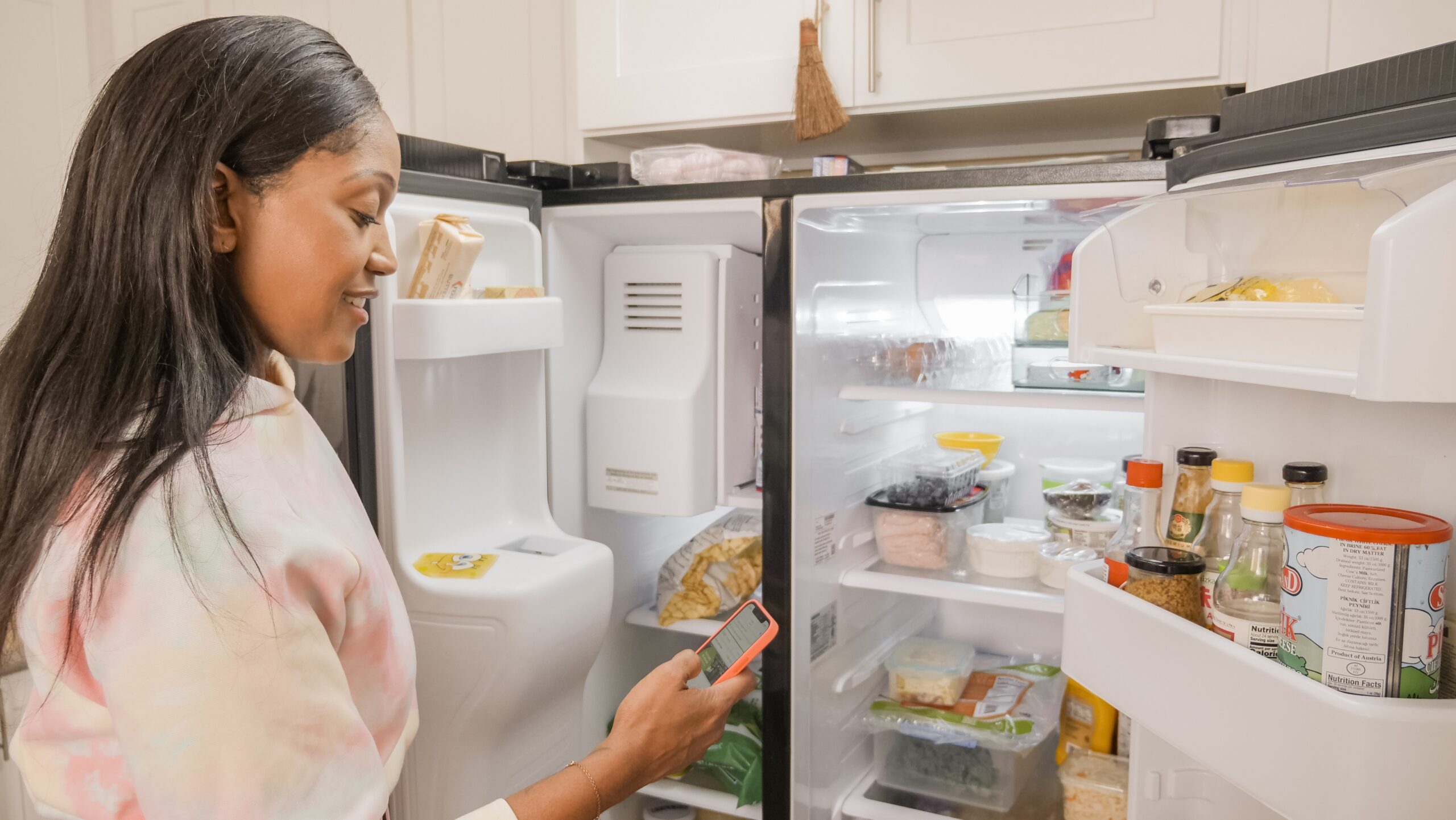 woman going through refrigerator