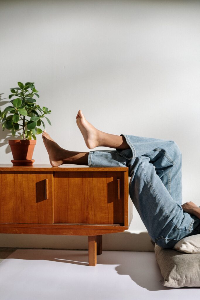 Legs propped up on bespoke furniture in living room