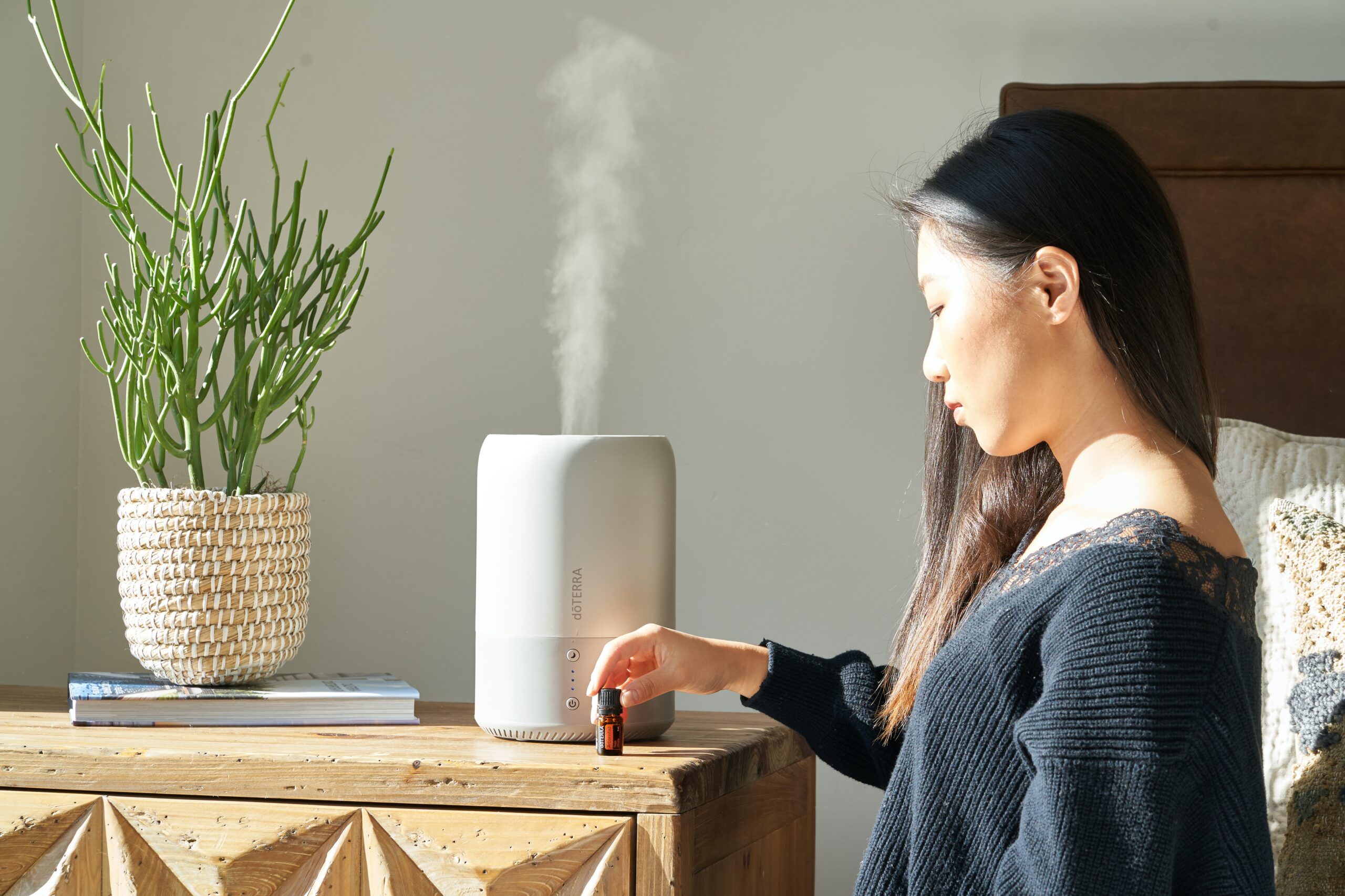Woman enojying an air purifier in her home