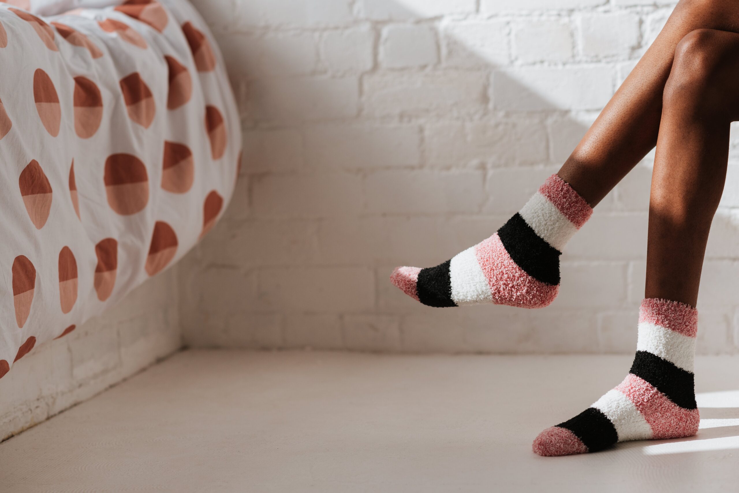 woman's feet in socks in bedroom