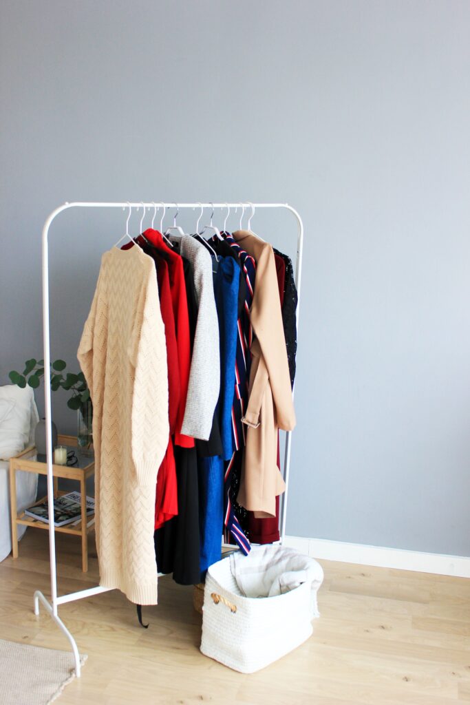 Organized rack of clothing with minimalist background