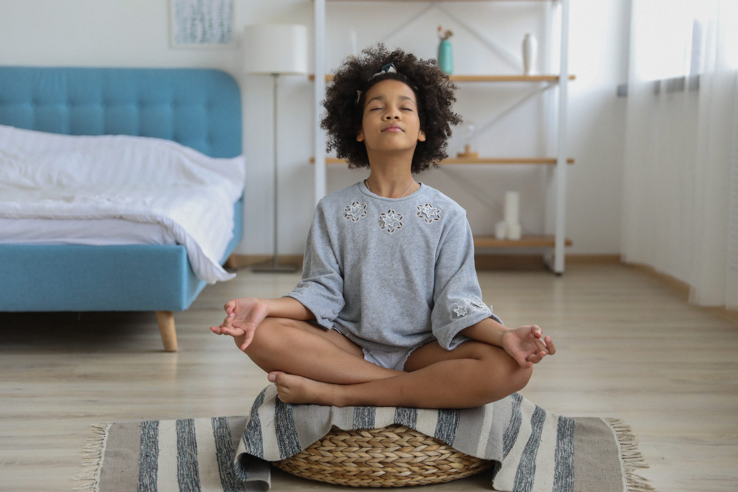 child meditating in their bedroom