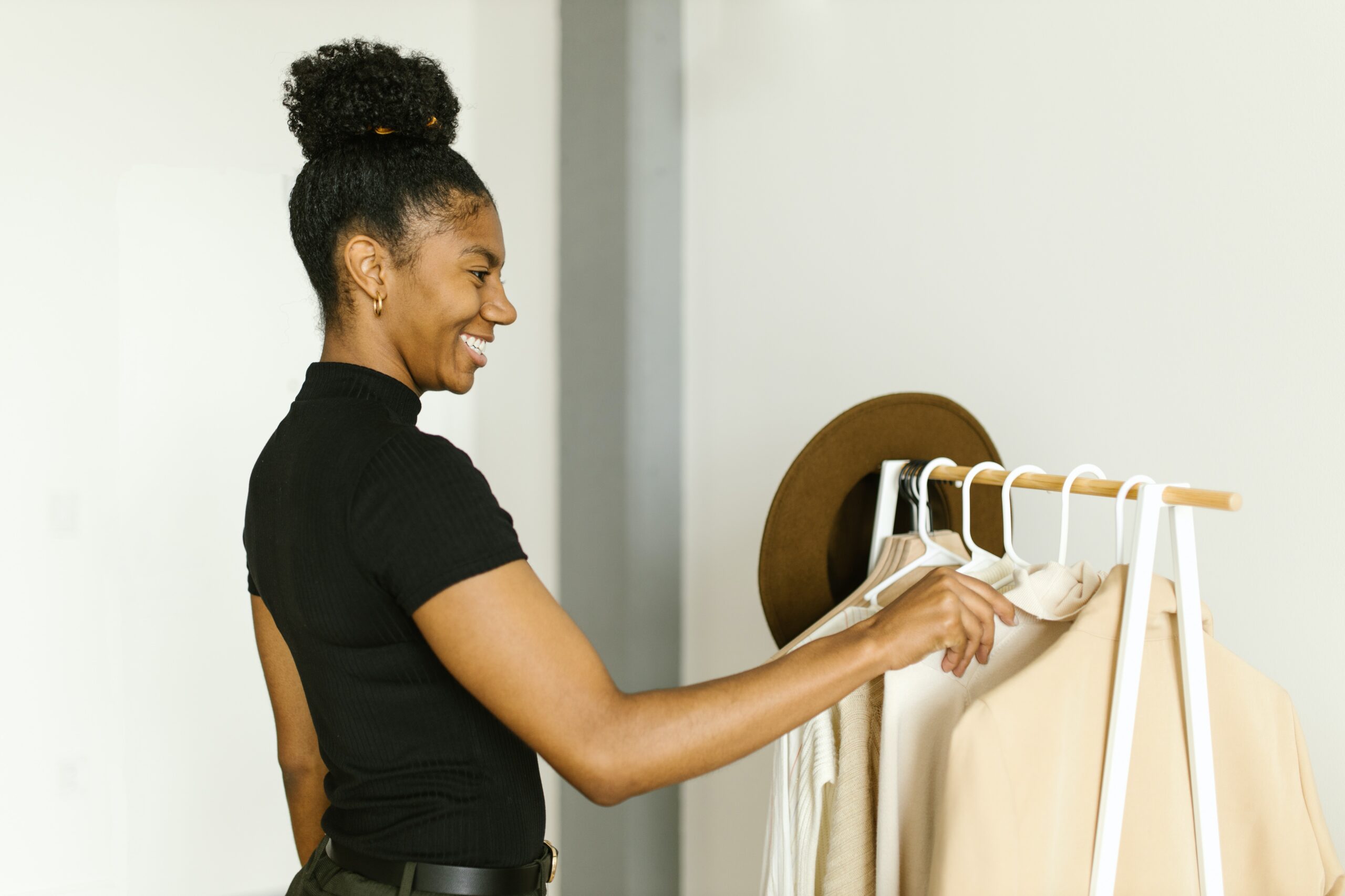 woman looking through clothing on clothing rack