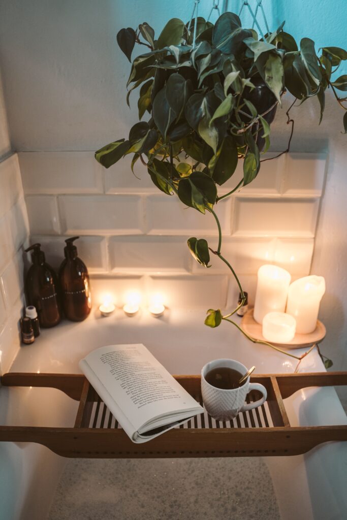 Bathtub with candles, coffee and book