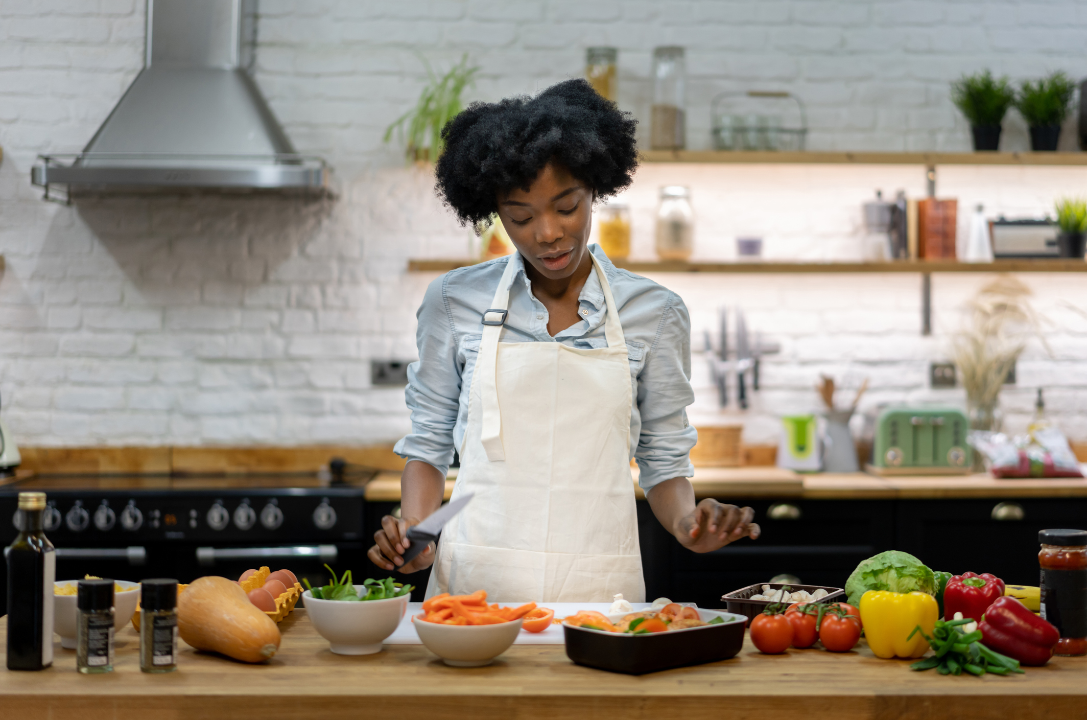 black woman cooking a healthy dinner at home â domestic lifestyle concepts