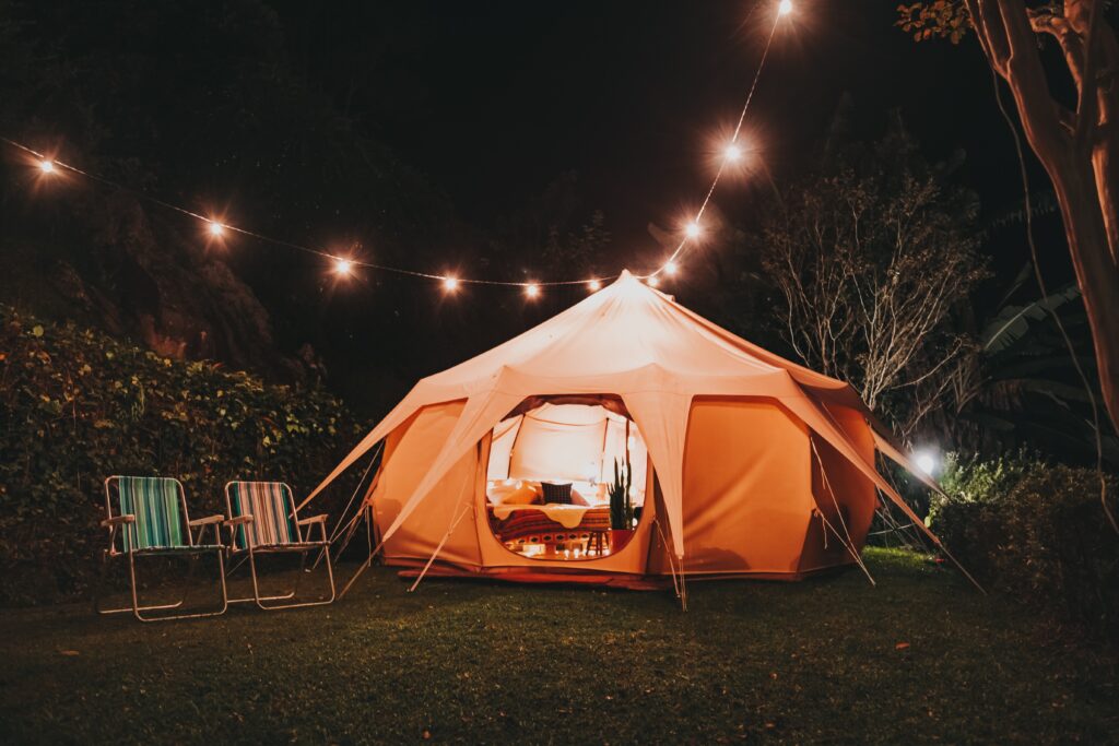 Tent in backyard with comfortable seating for outdoor movie night