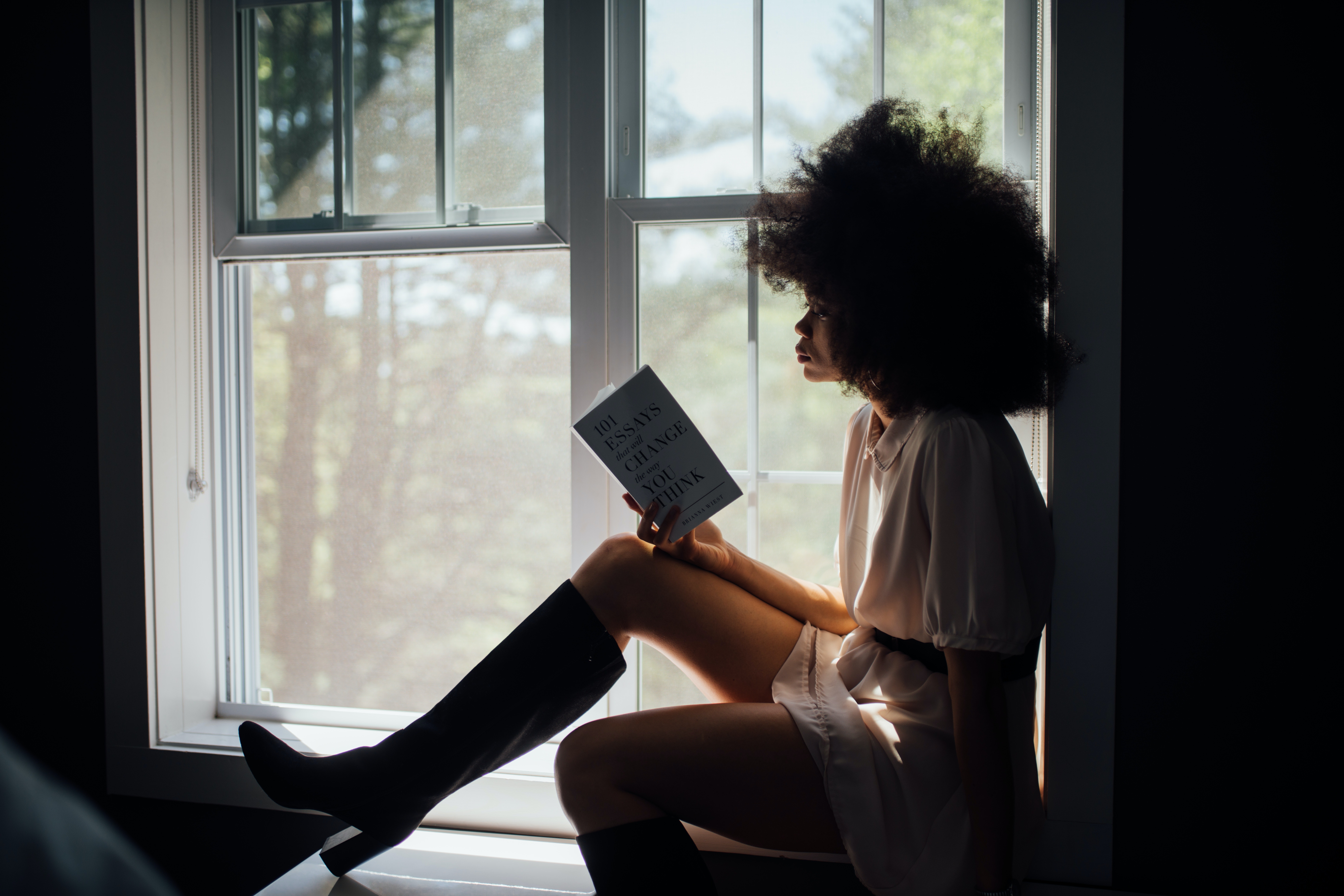 woman sitting reading in reading nook