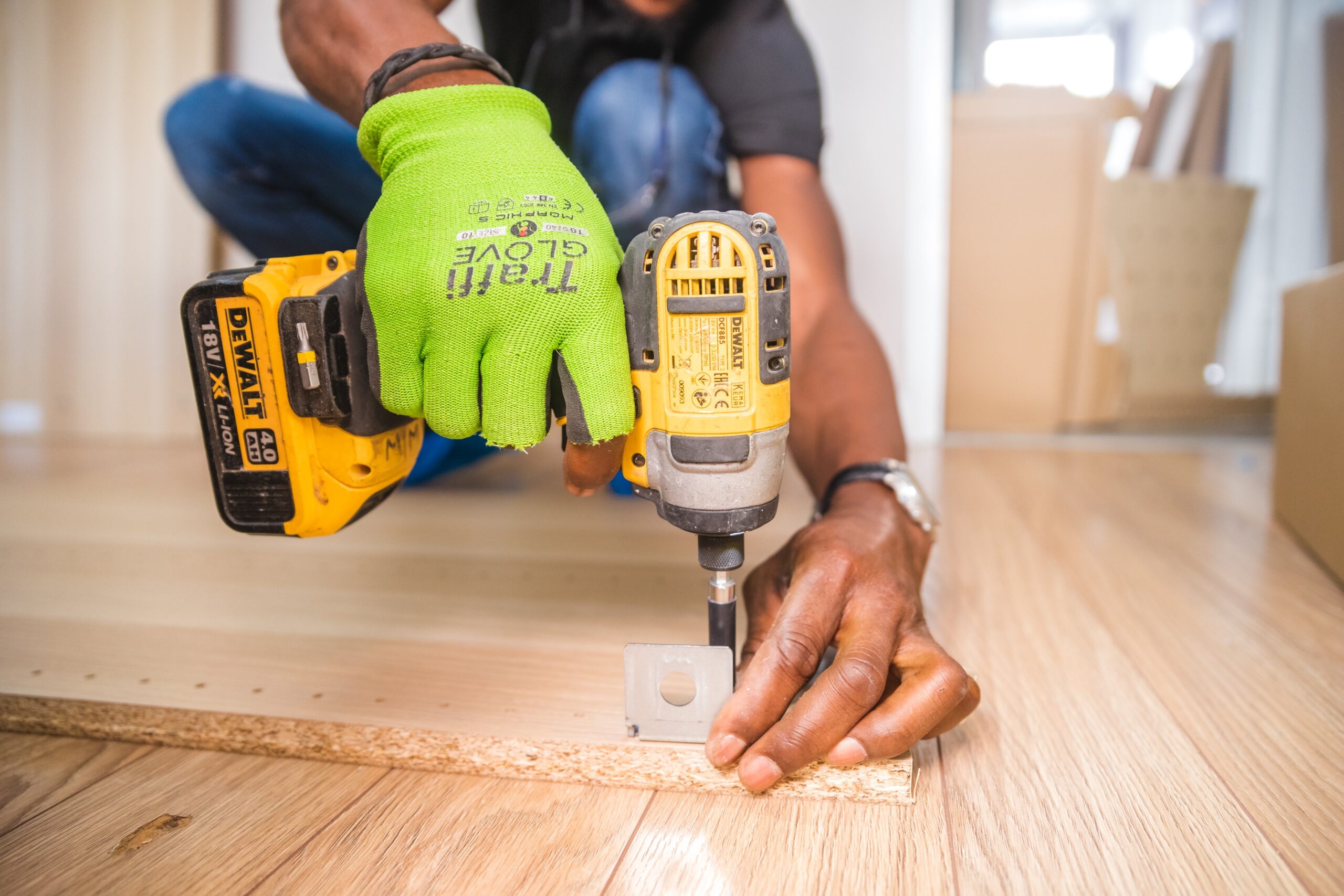 A man using a drill on wooden planks