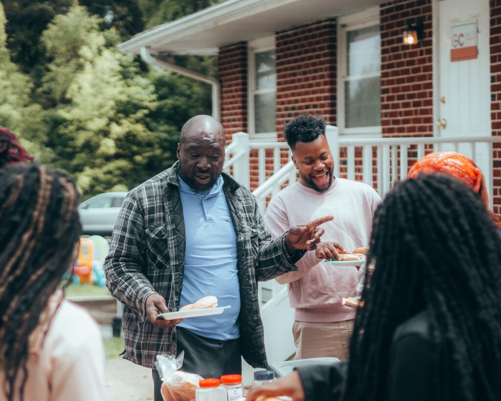 Partygoers grabbing food from a buffet line