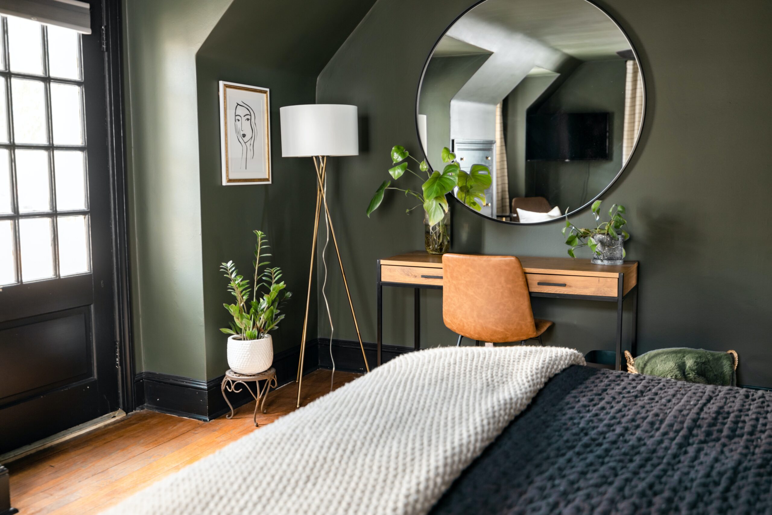A sage green bedroom with simple decor. Pictured: A bedroom.