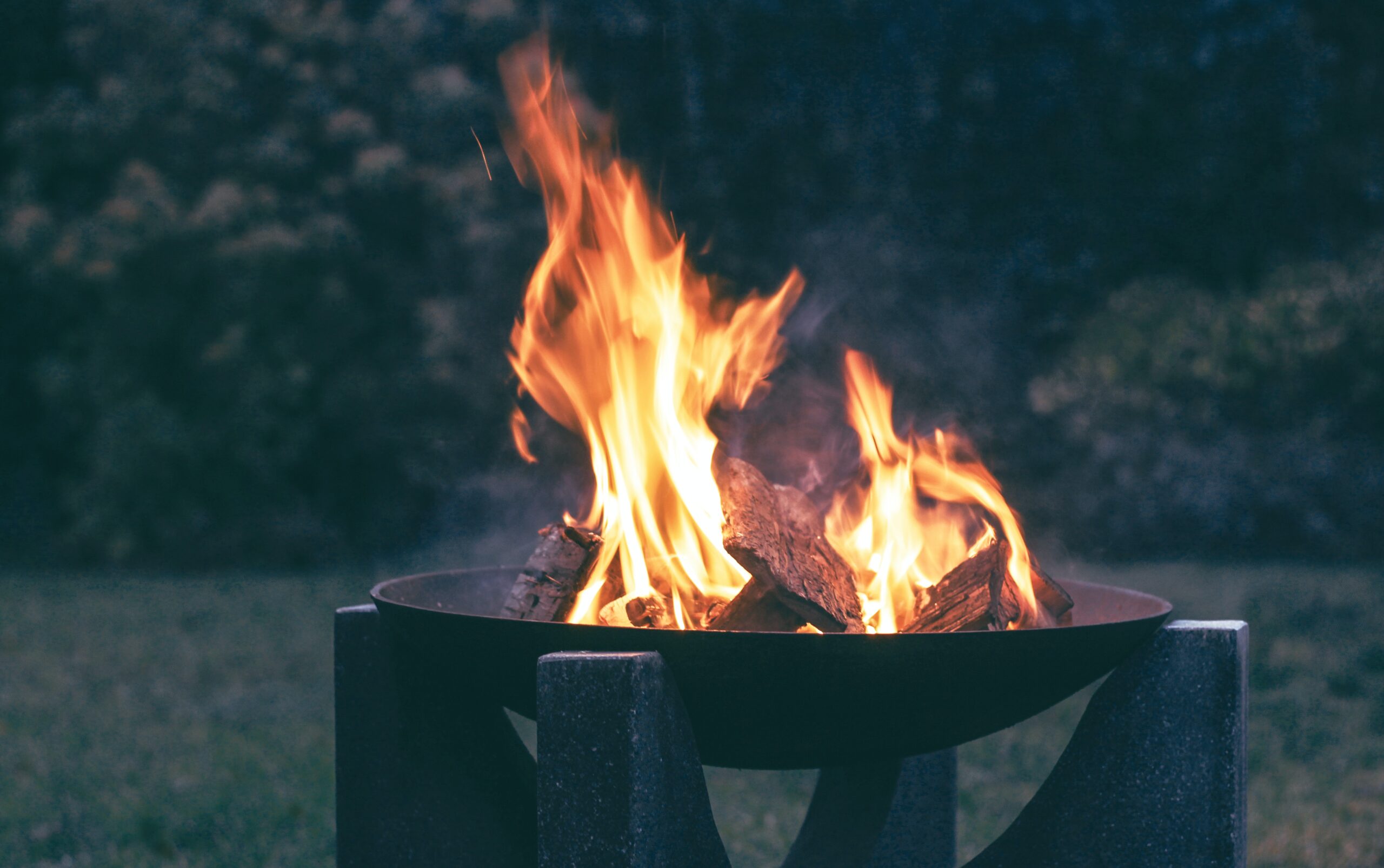 Create a backyard fire pit idea by adding a statement fire pit. Pictured: A fire pit.