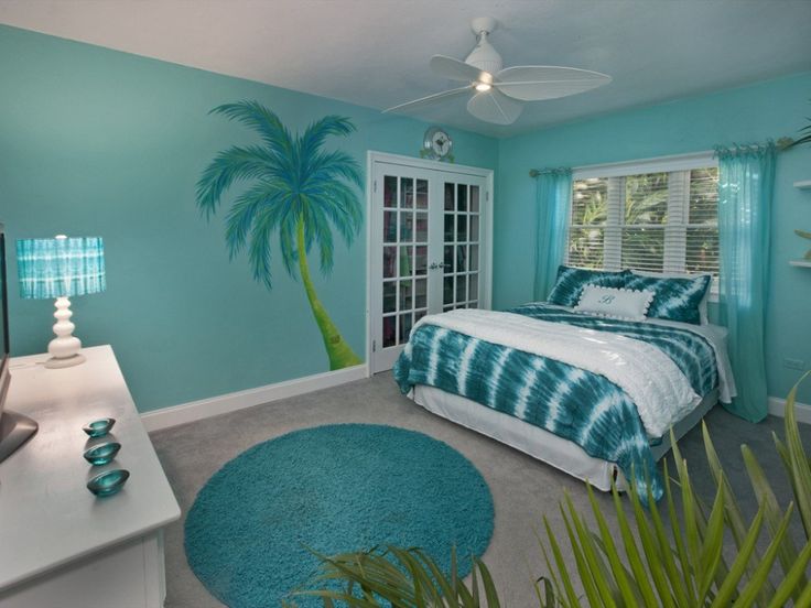 For those who want their room to fit the beach and ocean aesthetic, turquoise is one of the best paint colors for bedrooms. Pictured: A turquoise bedroom.