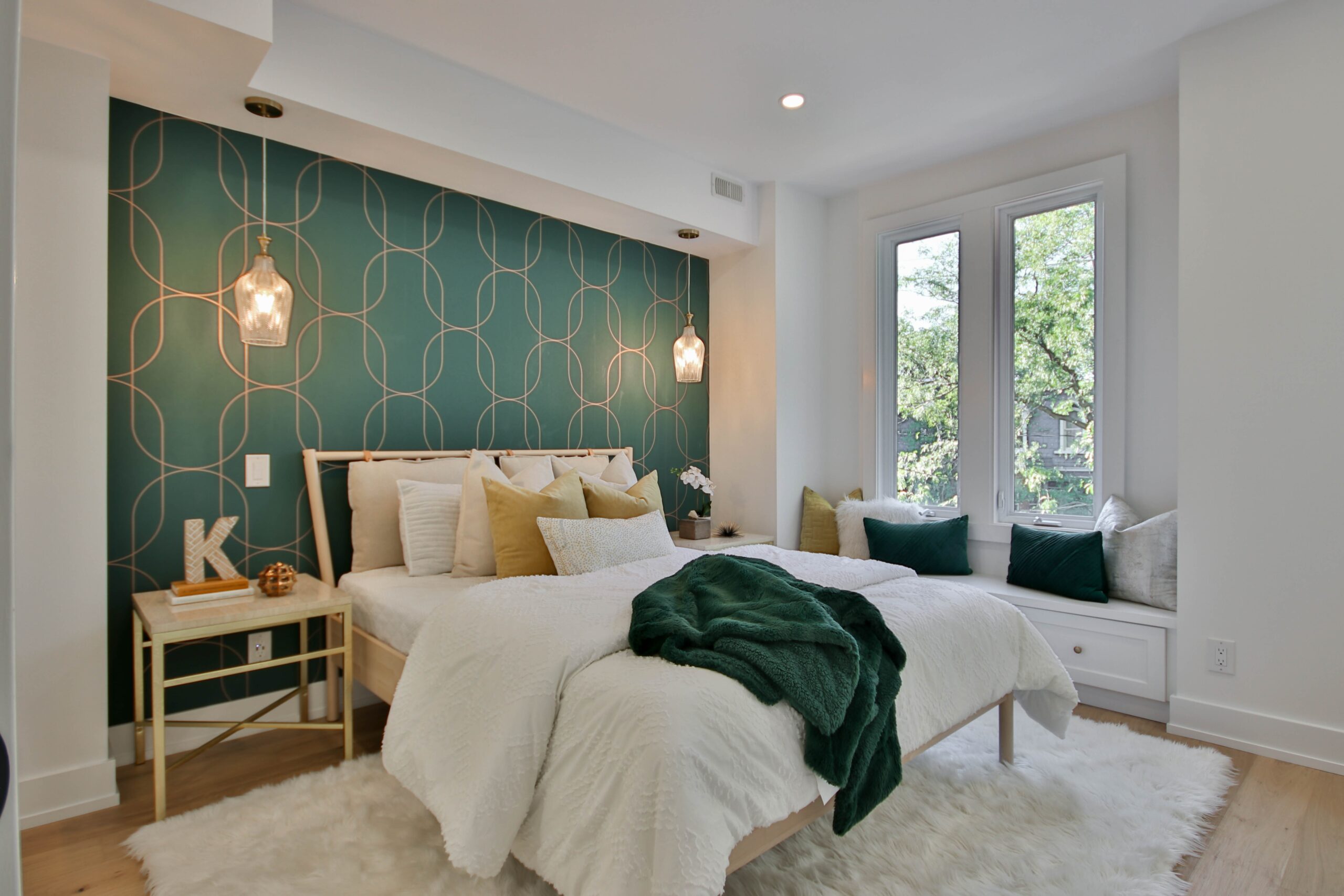 Sage green is one of the most calming colors to paint your bedroom. Pictured: A bedroom with a sage green wall and decor.