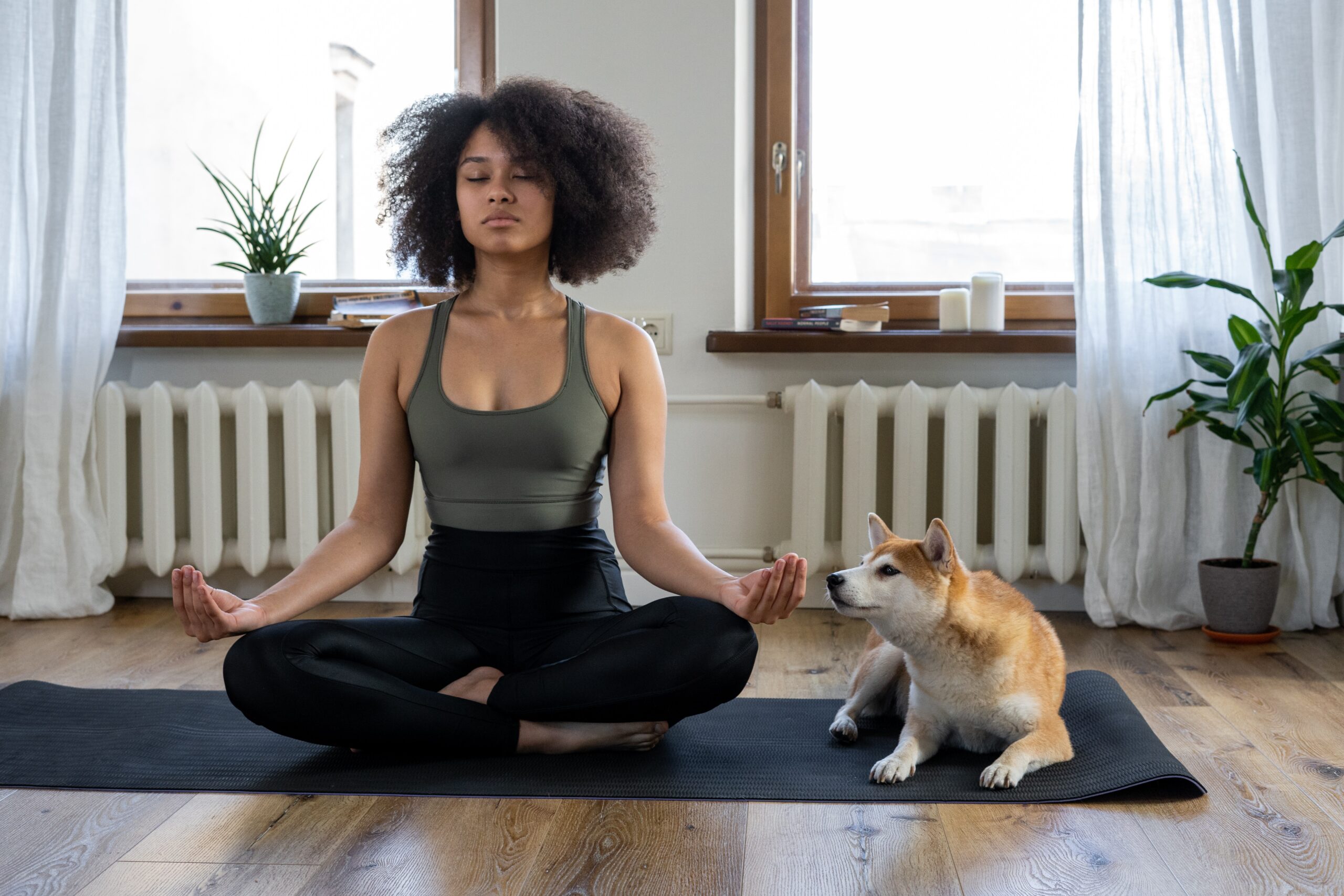 A woman doing yoga poses on a yoga mat