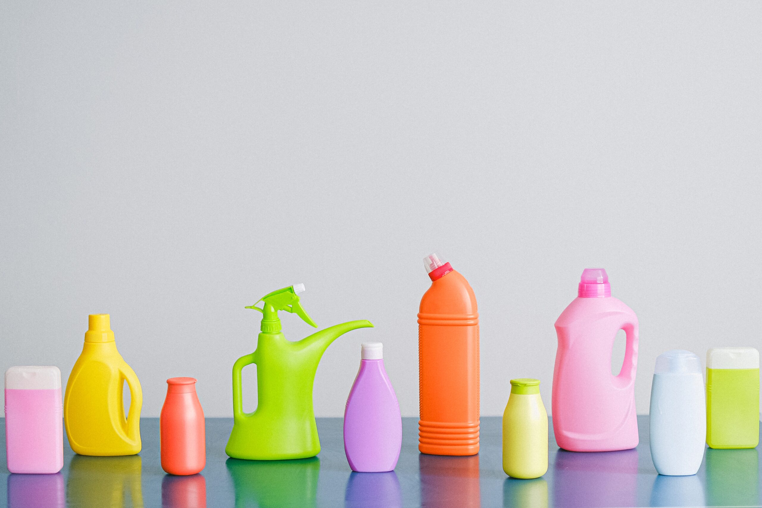 An assortment of unlabeled cleaning products in varying shapes, sizes, and colors