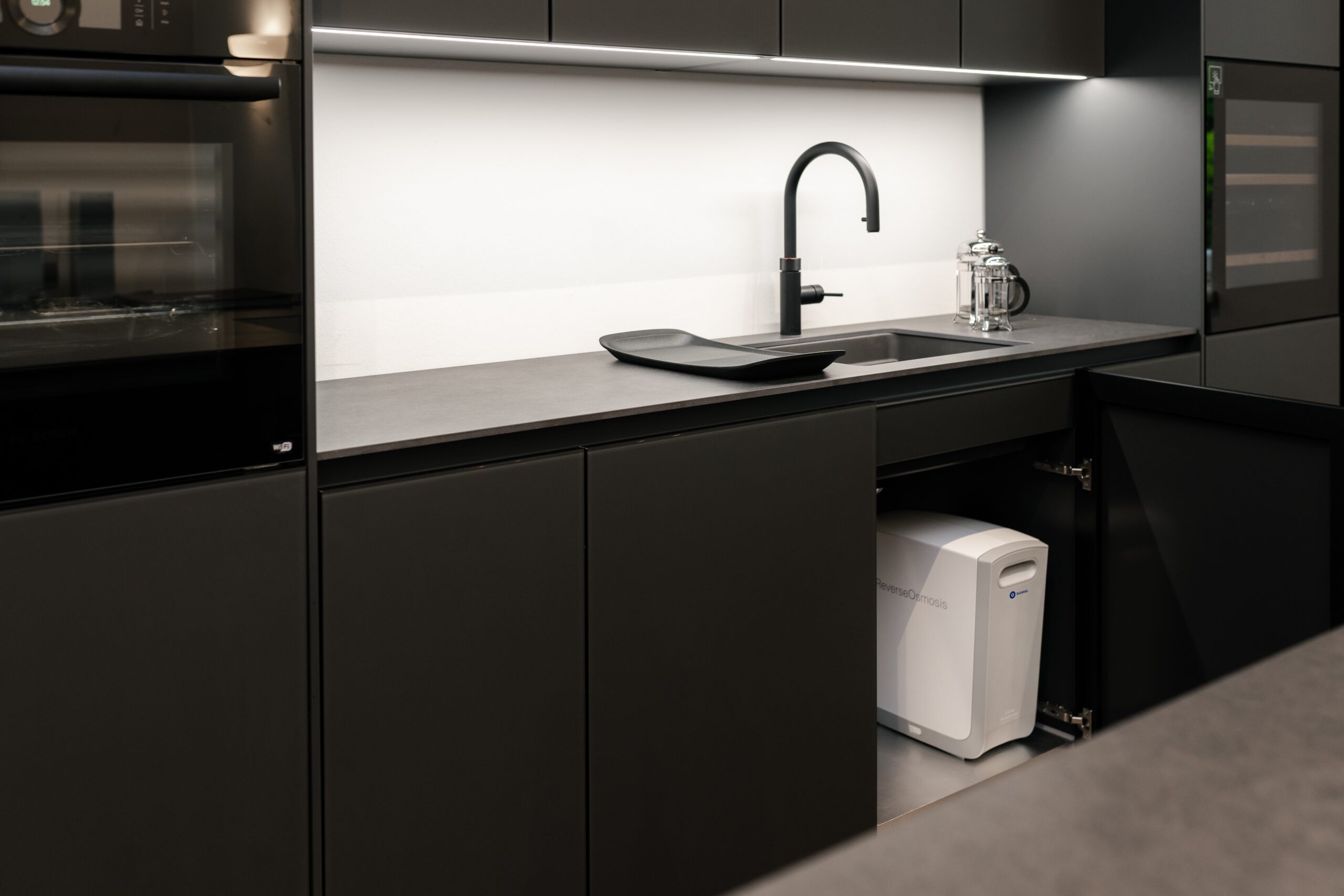 For those who really love the color black, pair your black kitchen countertops with all-black cabinets and appliances. Pictured: A black countertop with black appliances.