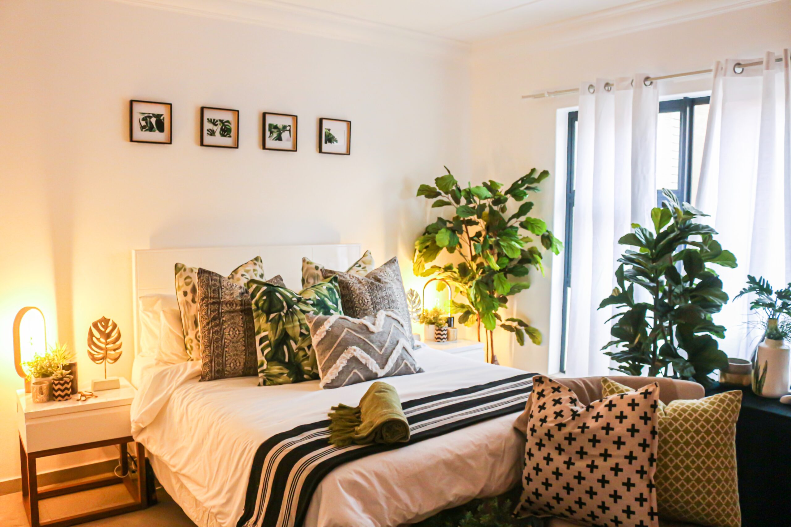 Add a bit of greenery to your boho bedroom to make the space in touch with nature. Pictured: A boho bedroom with plants.
