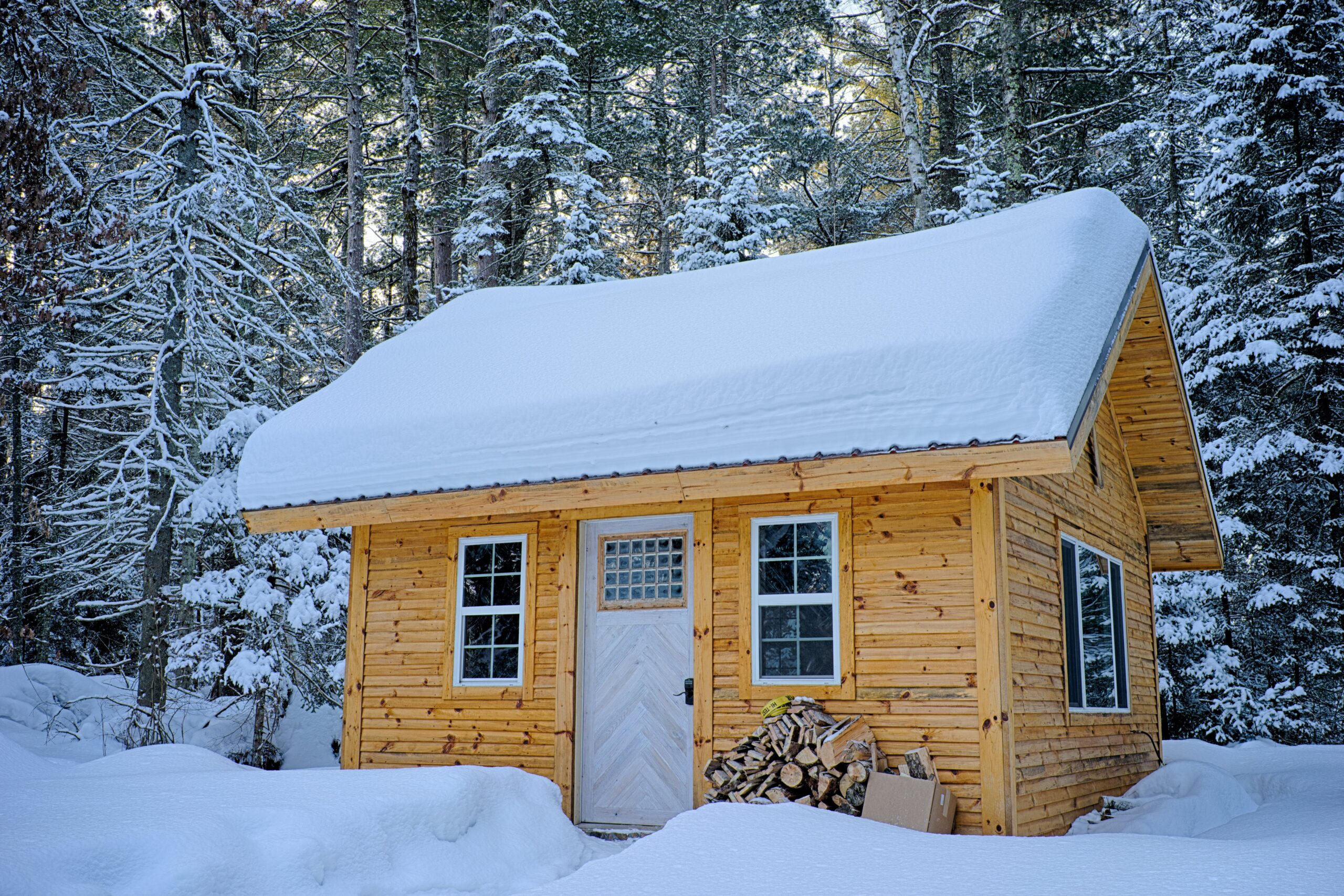 If you plan on converting a shed into a tiny home, heating and AC are some of the most important steps. Pictured: A tiny home in the snow.