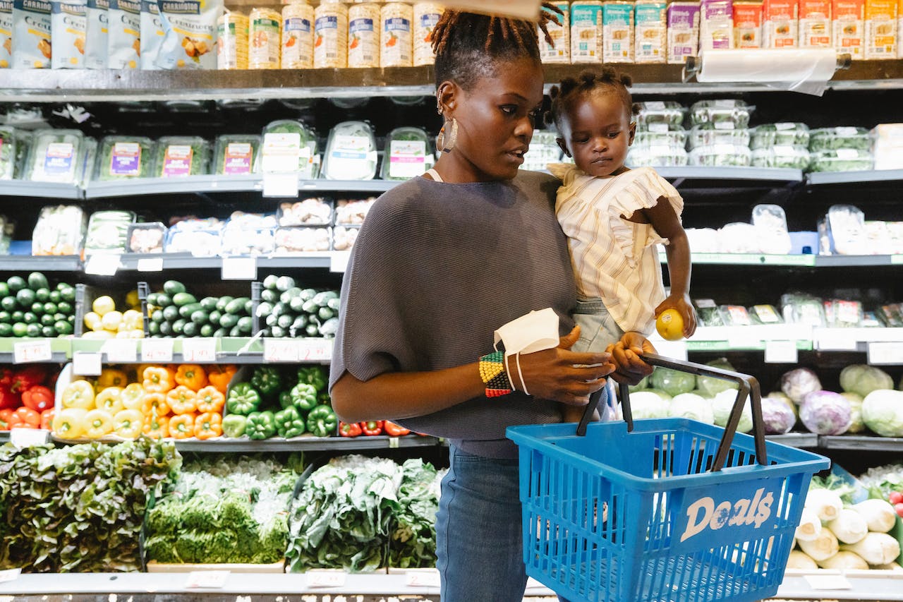 Instacart can be downloaded onto your devices for shopping. Pictured: A woman grocery shopping.