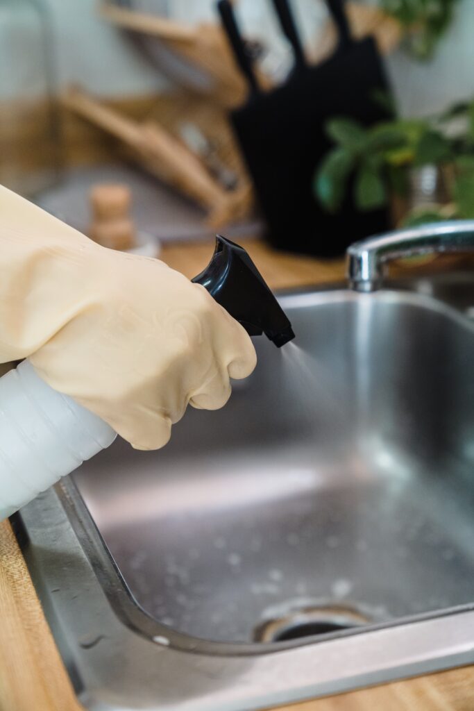 Person cleaning kitchen sink