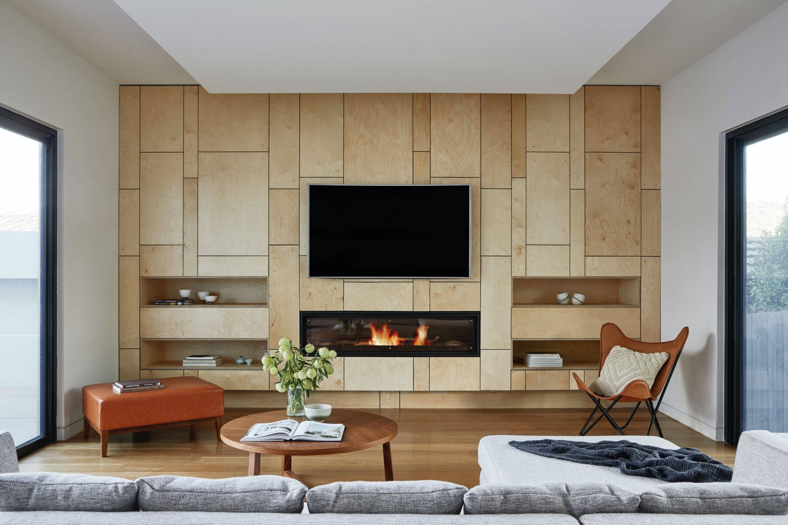 Add a TV above the fireplace for a seamless design with your small living room space. Pictured: A living room.