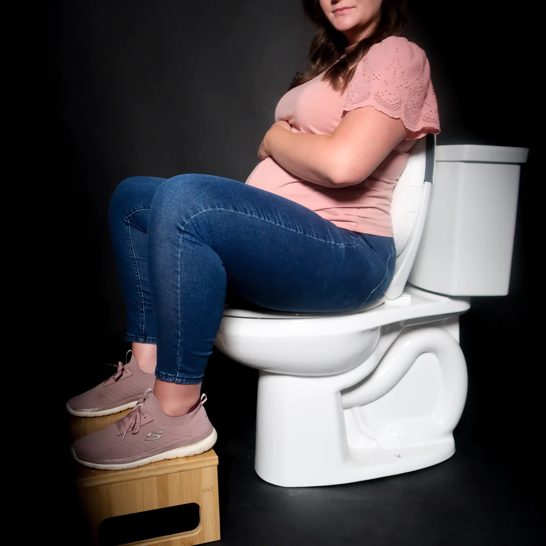 A pregnant woman using the Potty Pillow