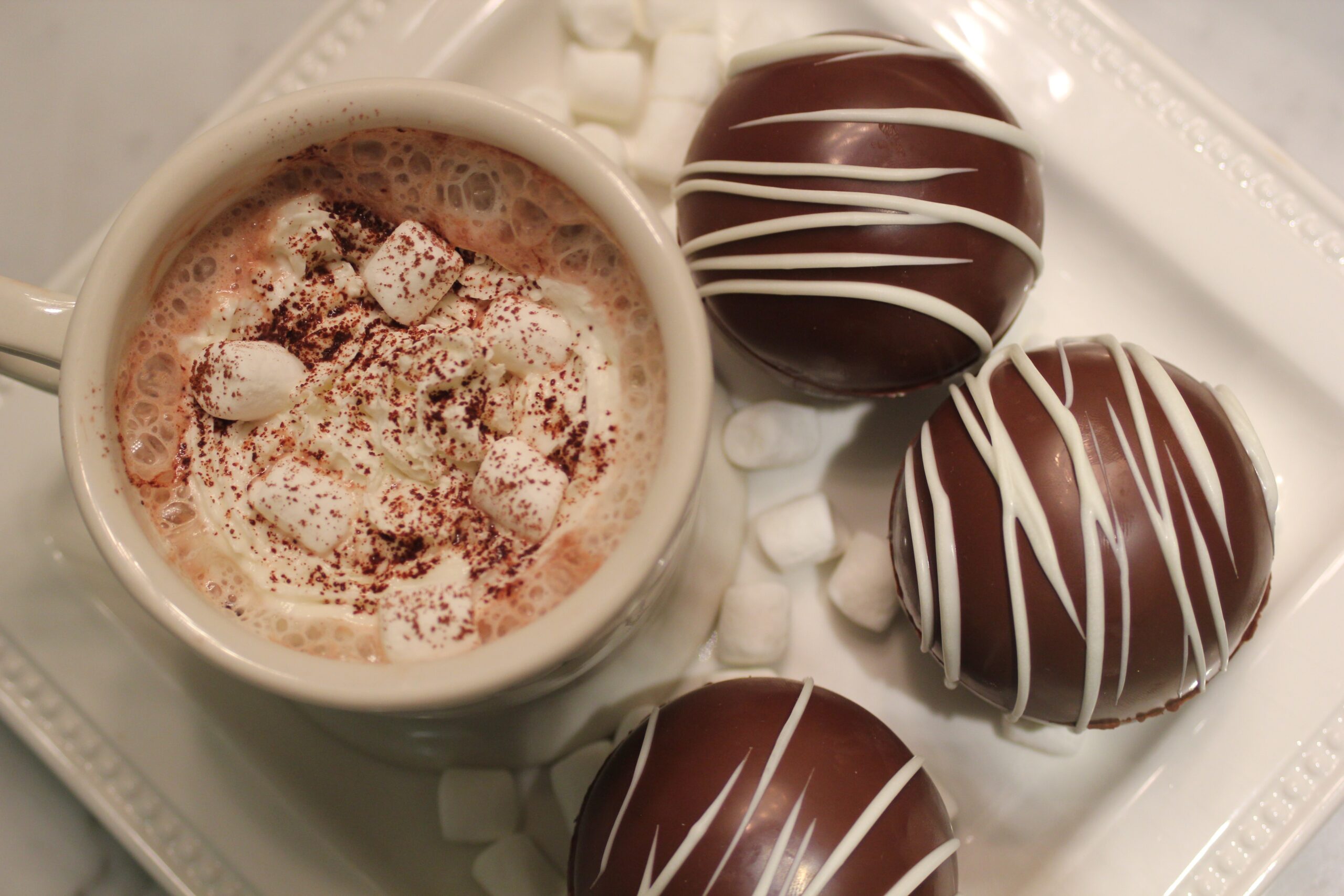 A plate of hot chocolate bombs and hot cocoa