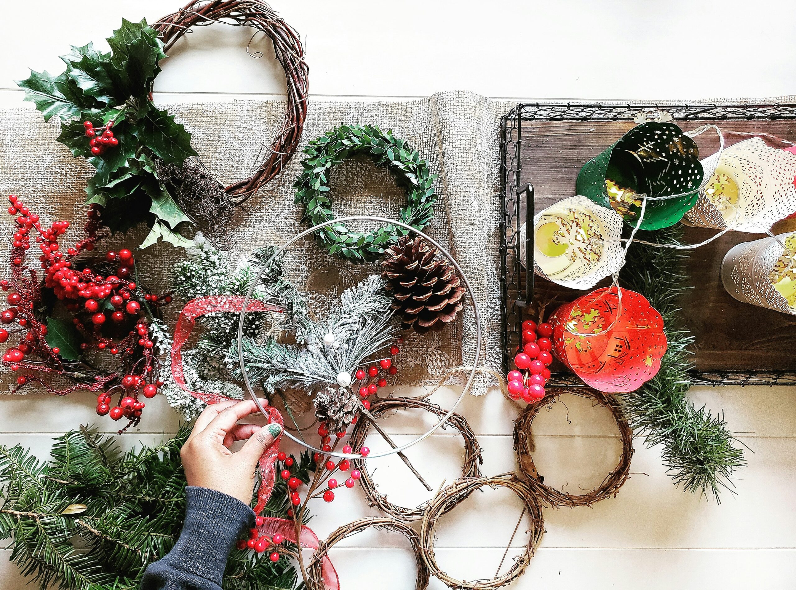 A person making a holiday wreath