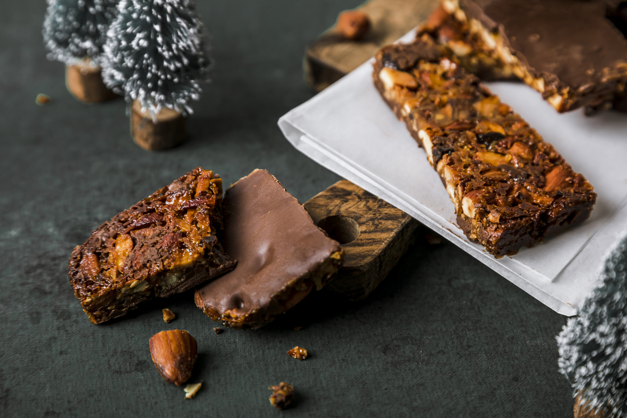 Christmas nougat with almond, orange and chocolate over dark green background. Ready to eat.