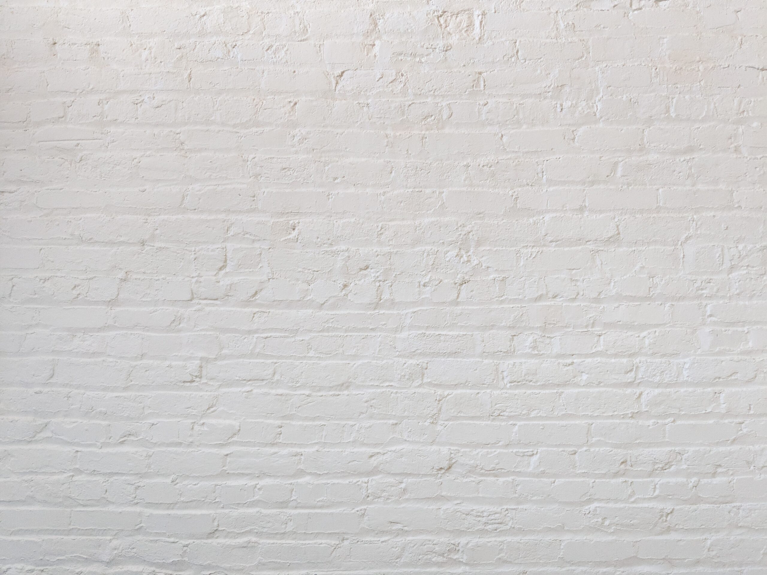 Use brick for a clean home office background that looks productive and serious to your coworkers. Pictured: A white brick wall.