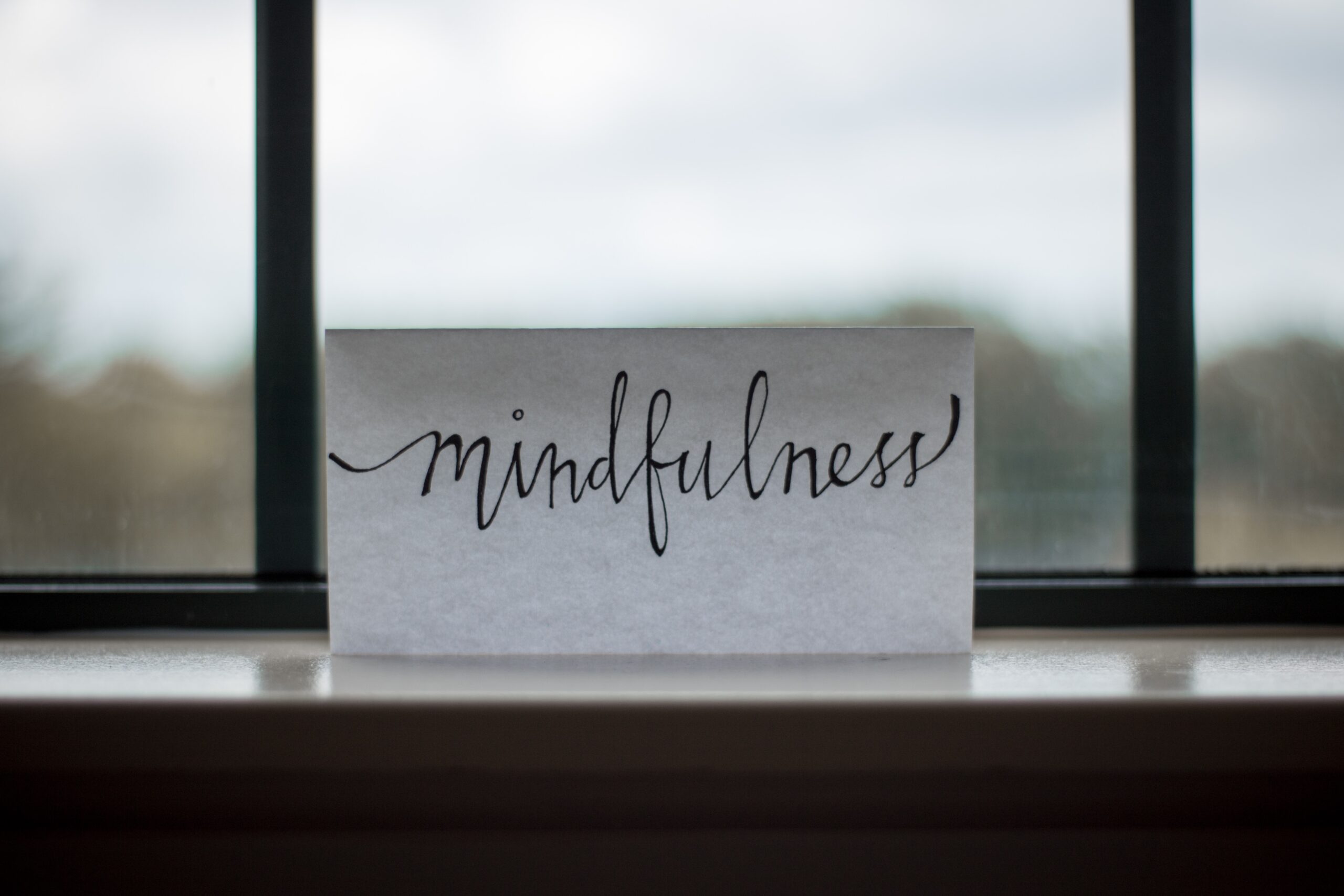 Incorporate senses into your zen meditation room and practice using sound. Pictured: A sign with the word 'mindfulness' written on it.