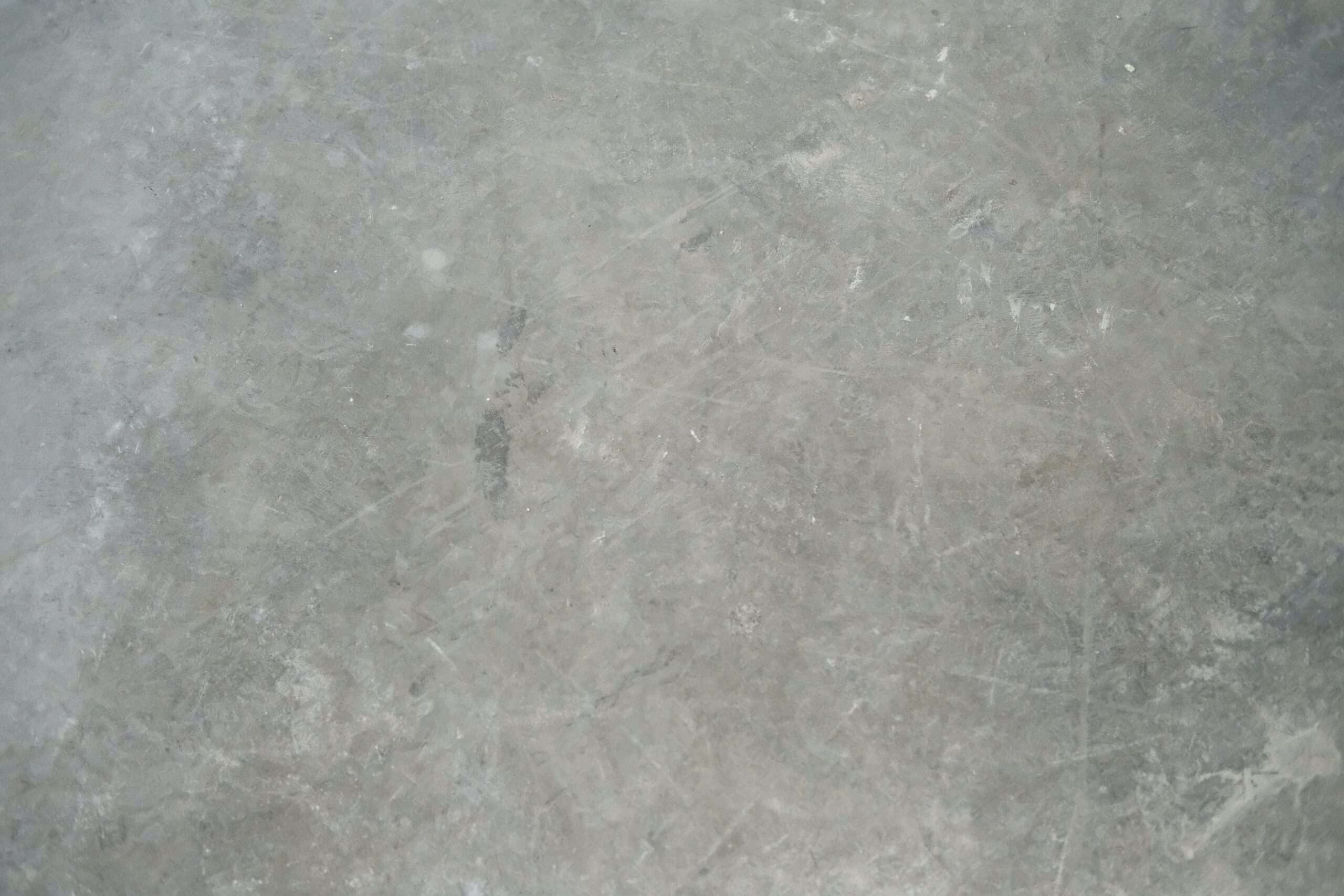 Utilize the brutalist interior design concept for this kitchen floor idea. Pictured: Concrete flooring.
