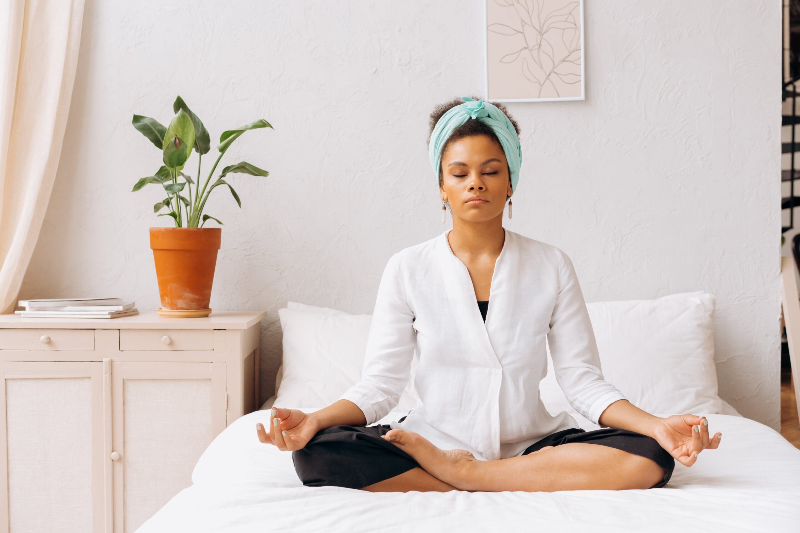 woman meditating in bed