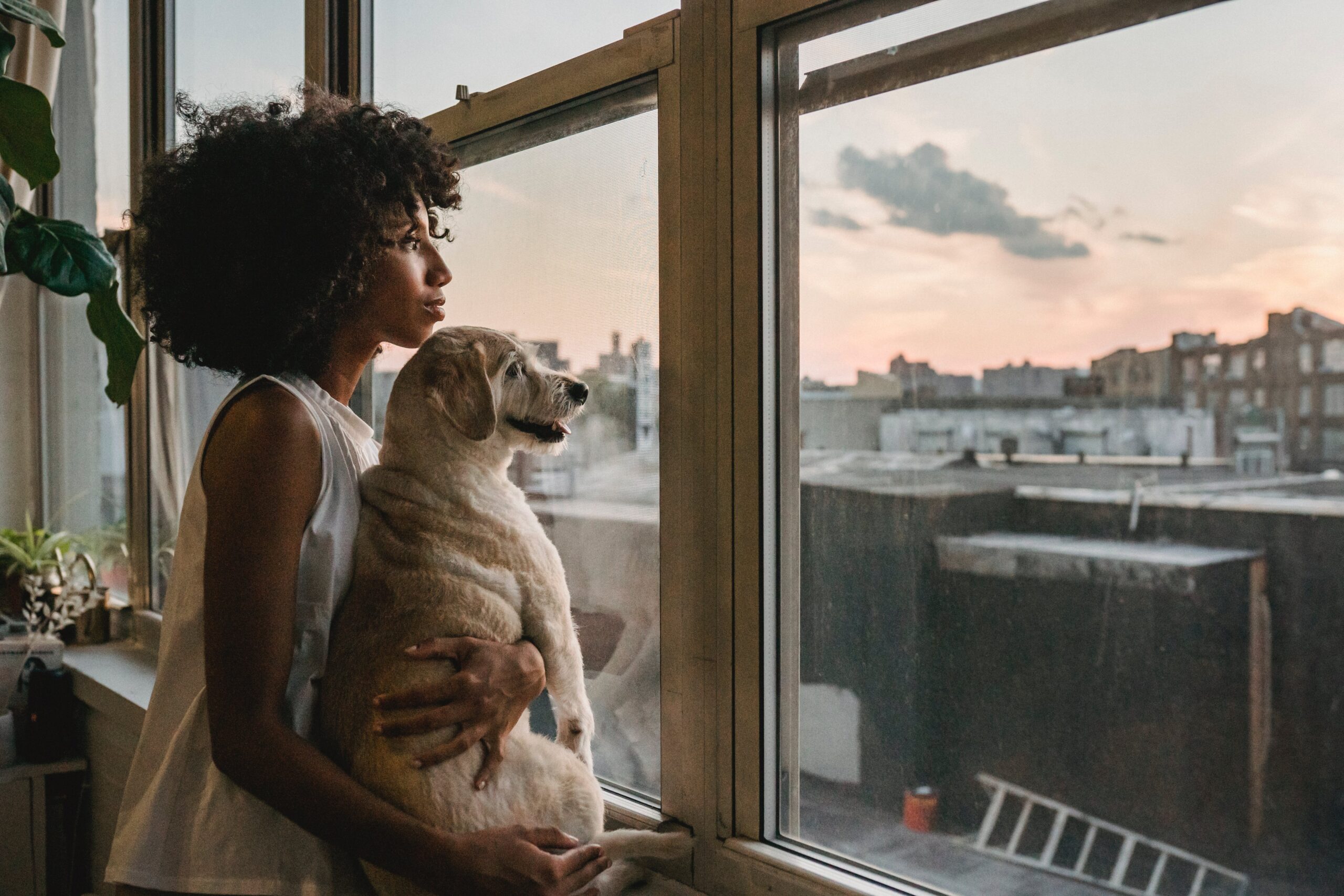 woman looking outside of window