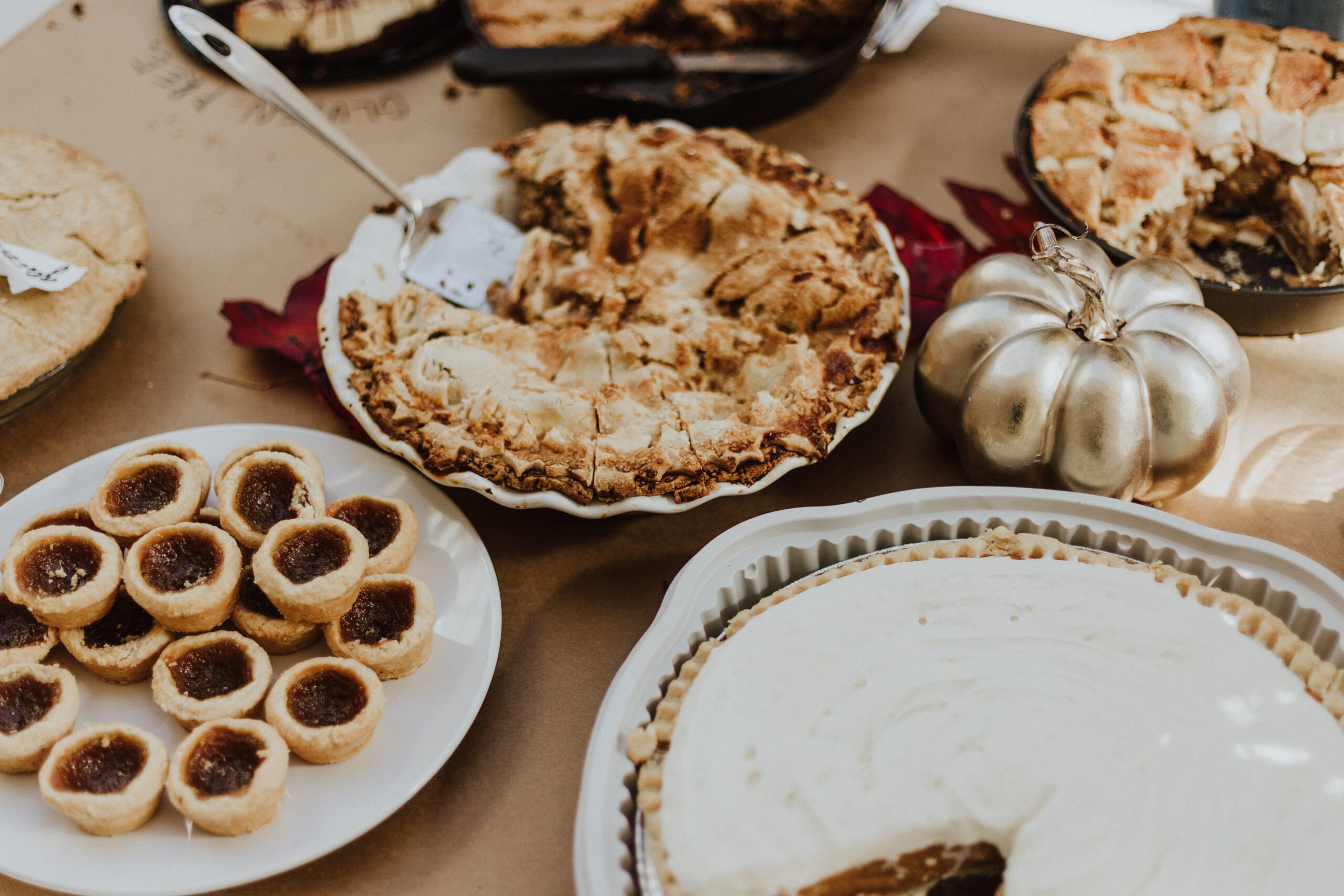 Your menu is one of most important friendsgiving ideas. Plan out a menu by using these hacks and ideas. Pictured: A table with desserts.