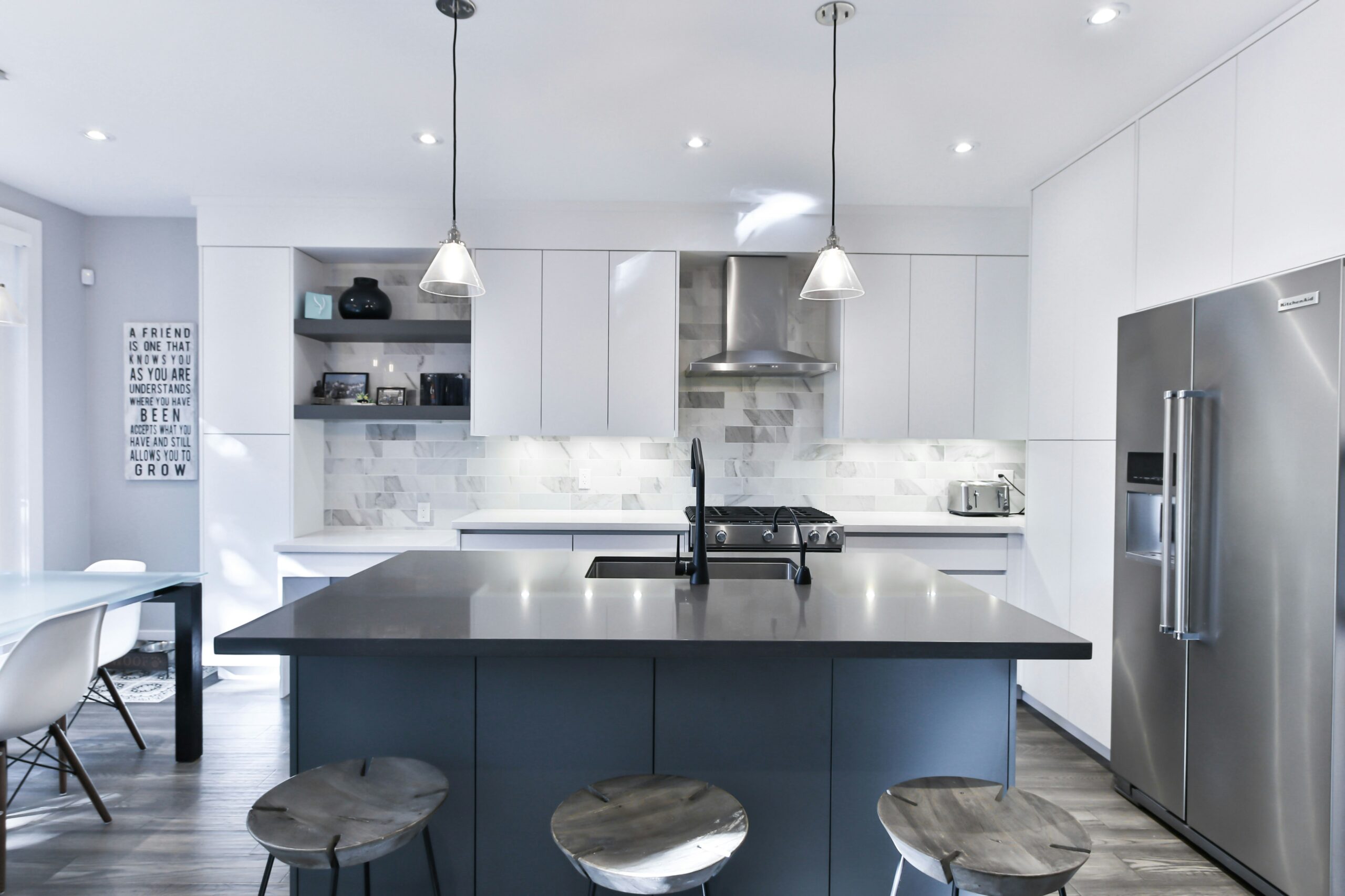 Stainless steel appliances have been a kitchen staple for years, but it's no surprise that they'll be a 2024 kitchen trend. Pictured: A kitchen with stainless steel appliances.