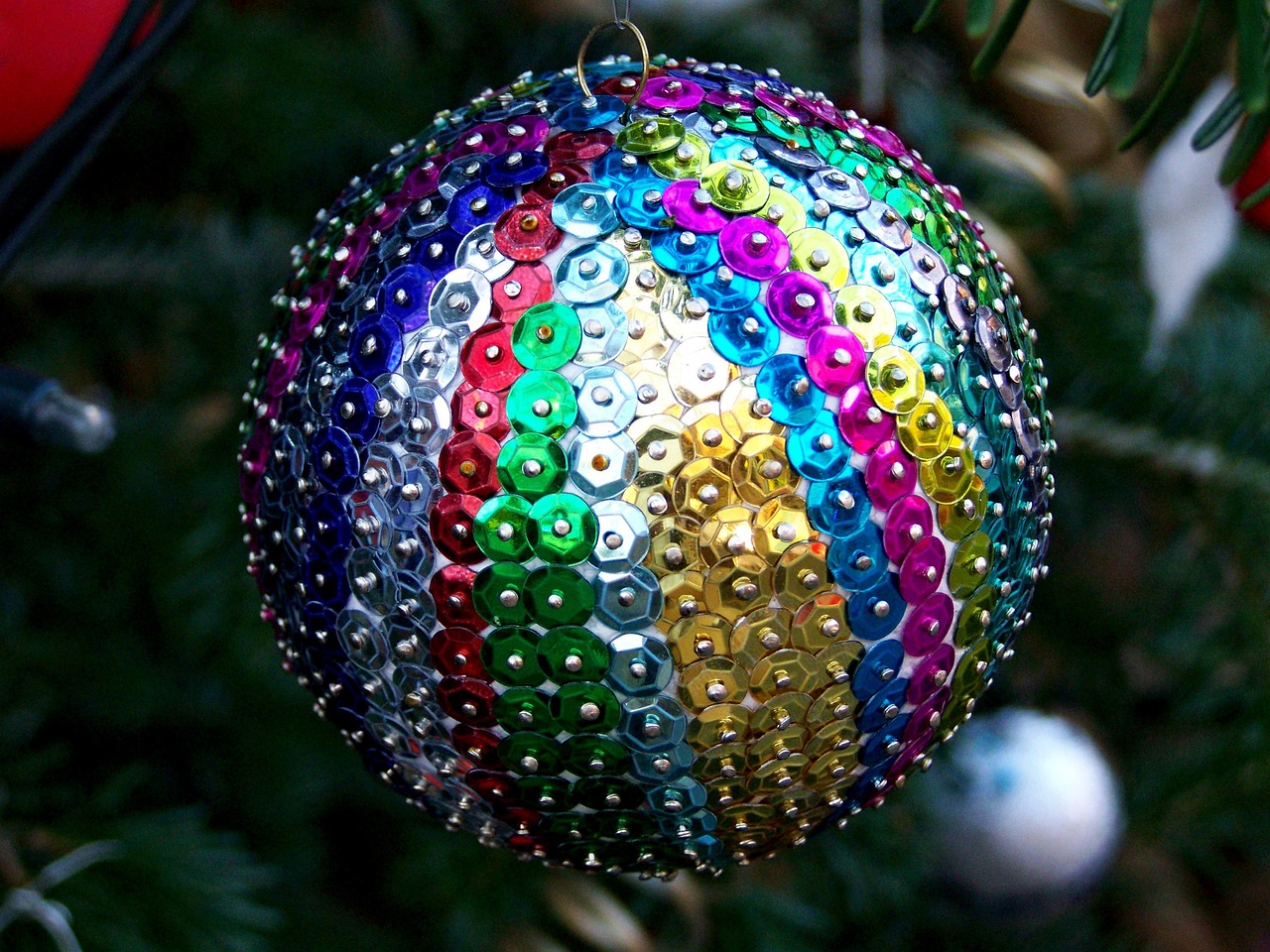 Use the colors of the rainbow for this colorful and vibrant Christmas tree theme. Pictured: A tree with rainbow colorful ornaments