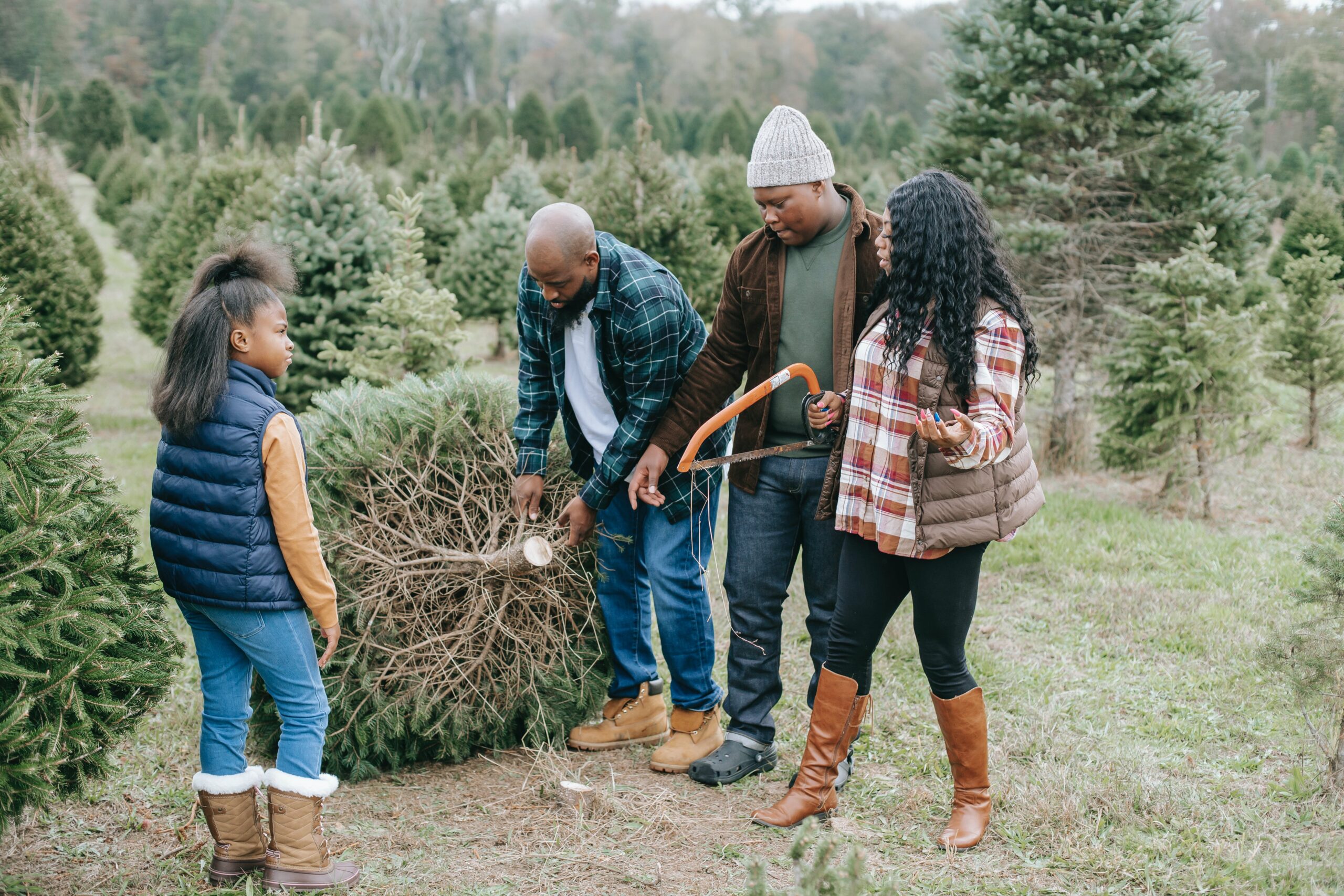 family cutting down Christmas tree
