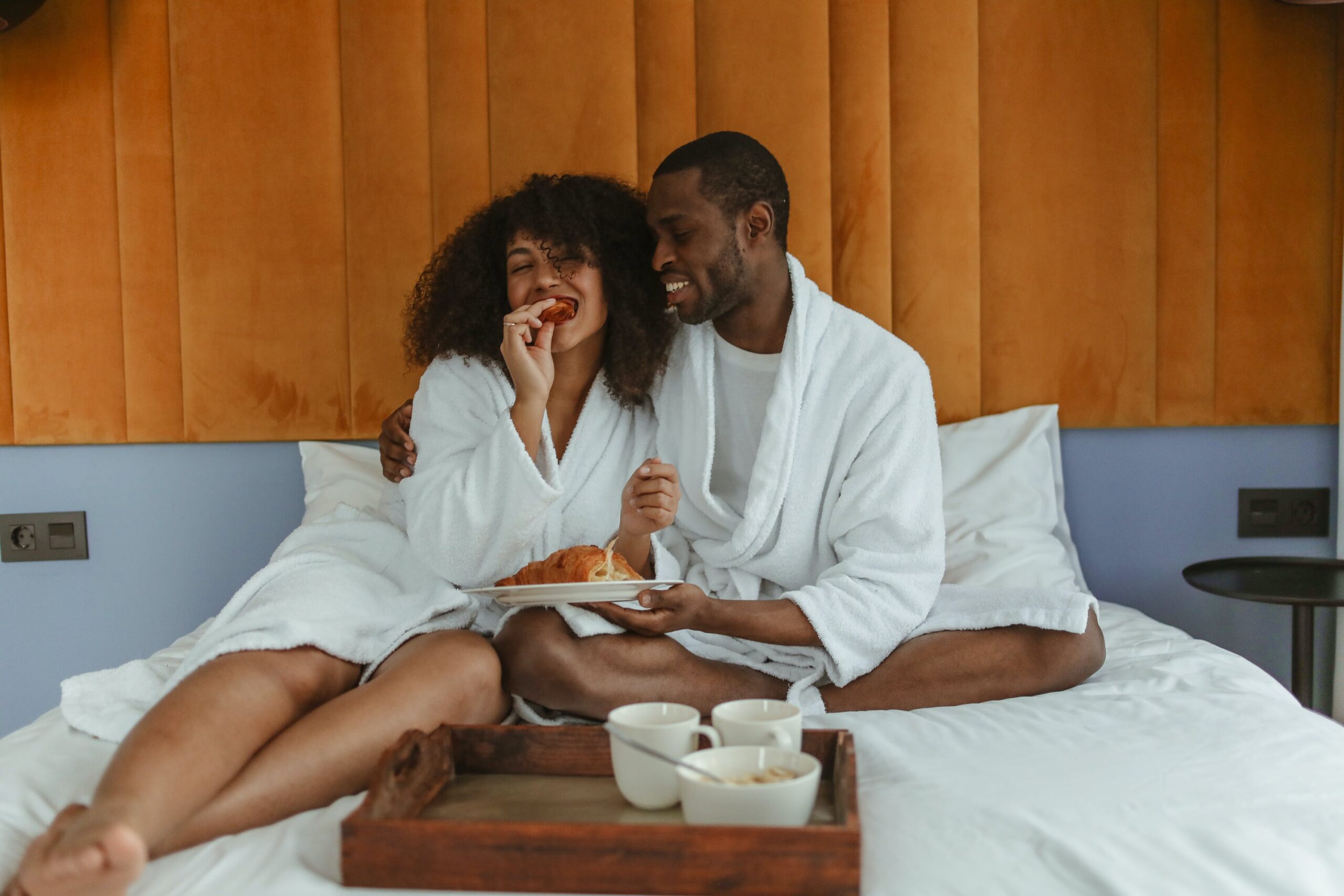couple in bed with breakfast