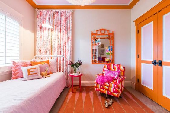 Orange and purple are great for a color block bedroom. Pictured: An orange bedroom.
