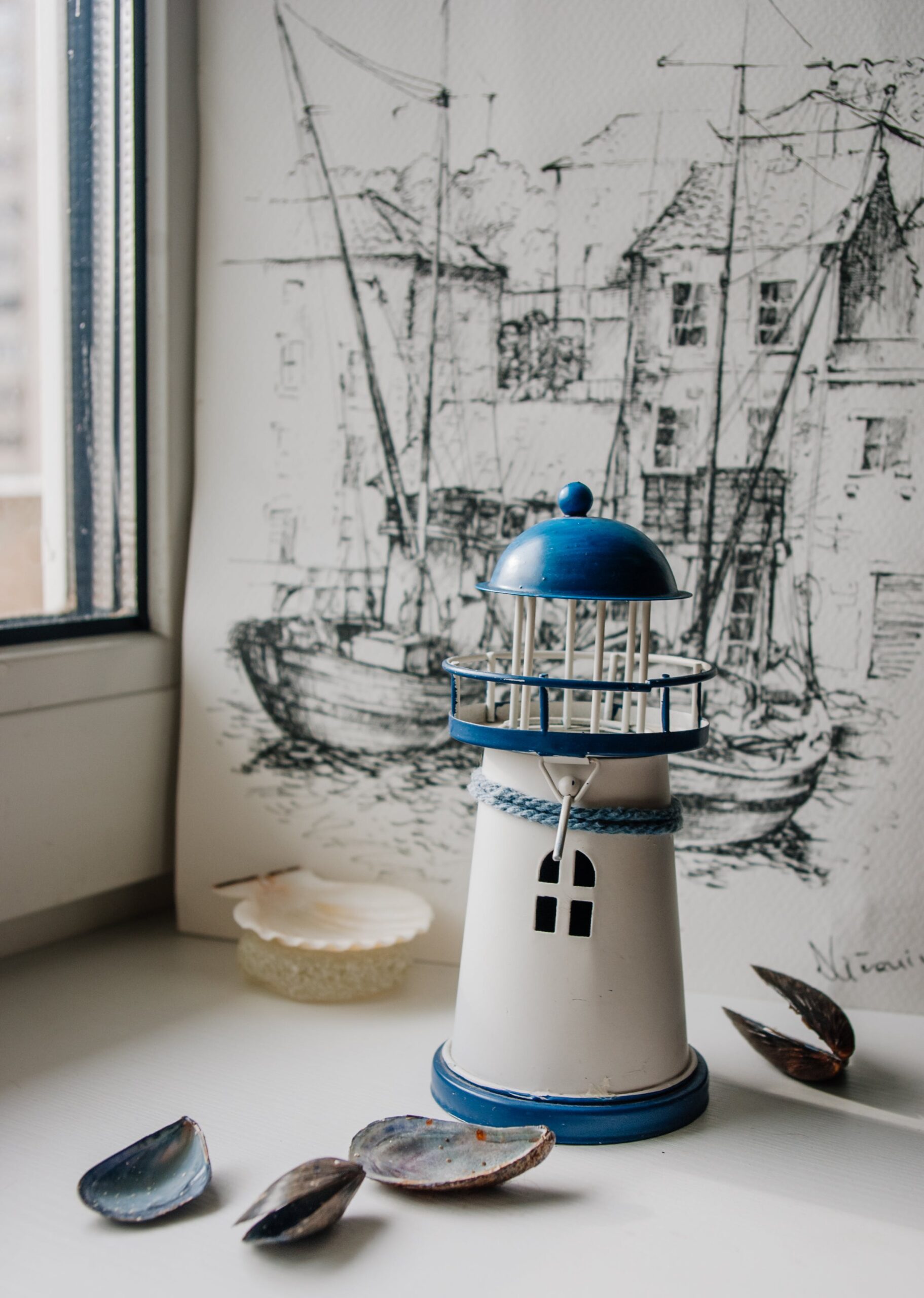 Nautical lighthouse toy with pencil sketch arranged on table