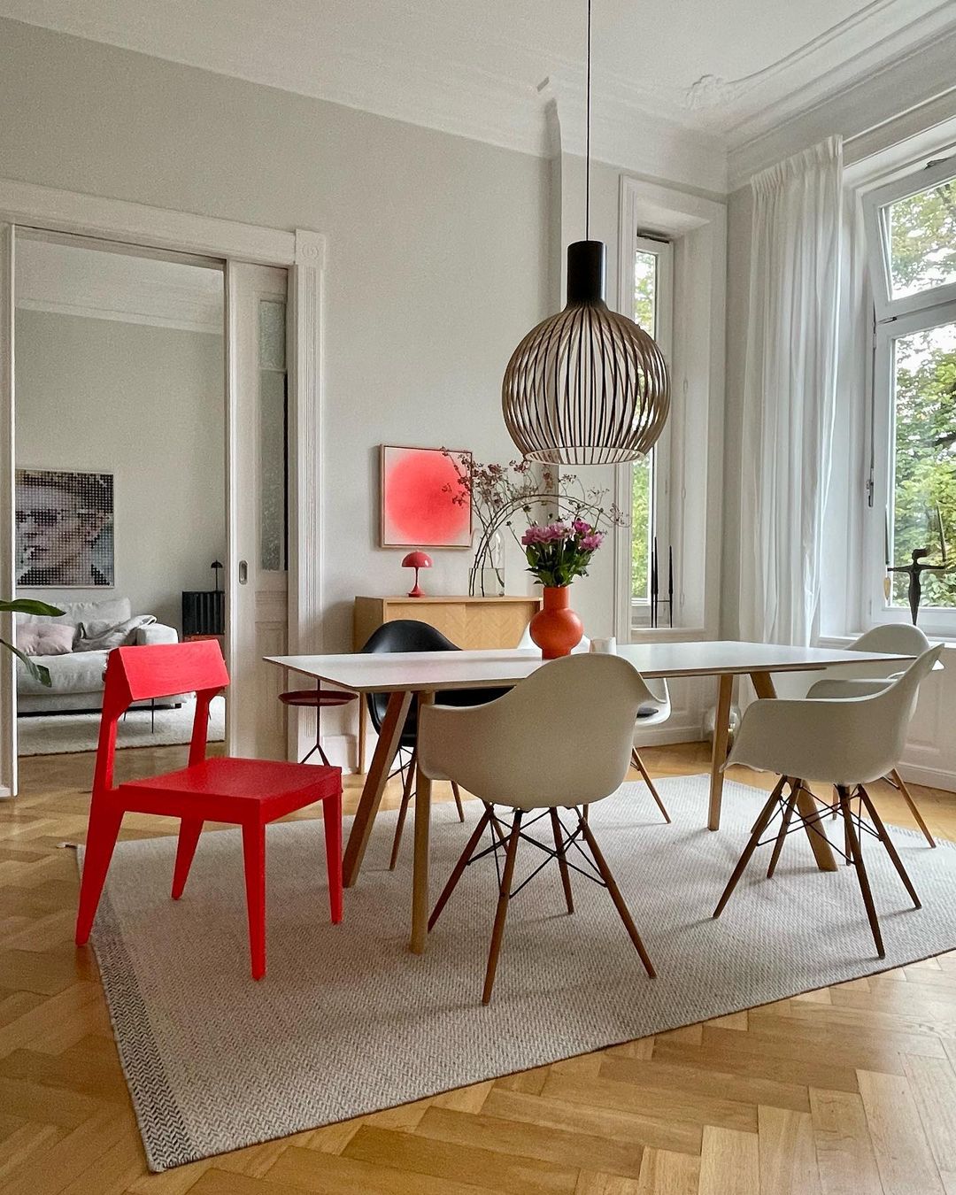 A red chair in a neutral dining room