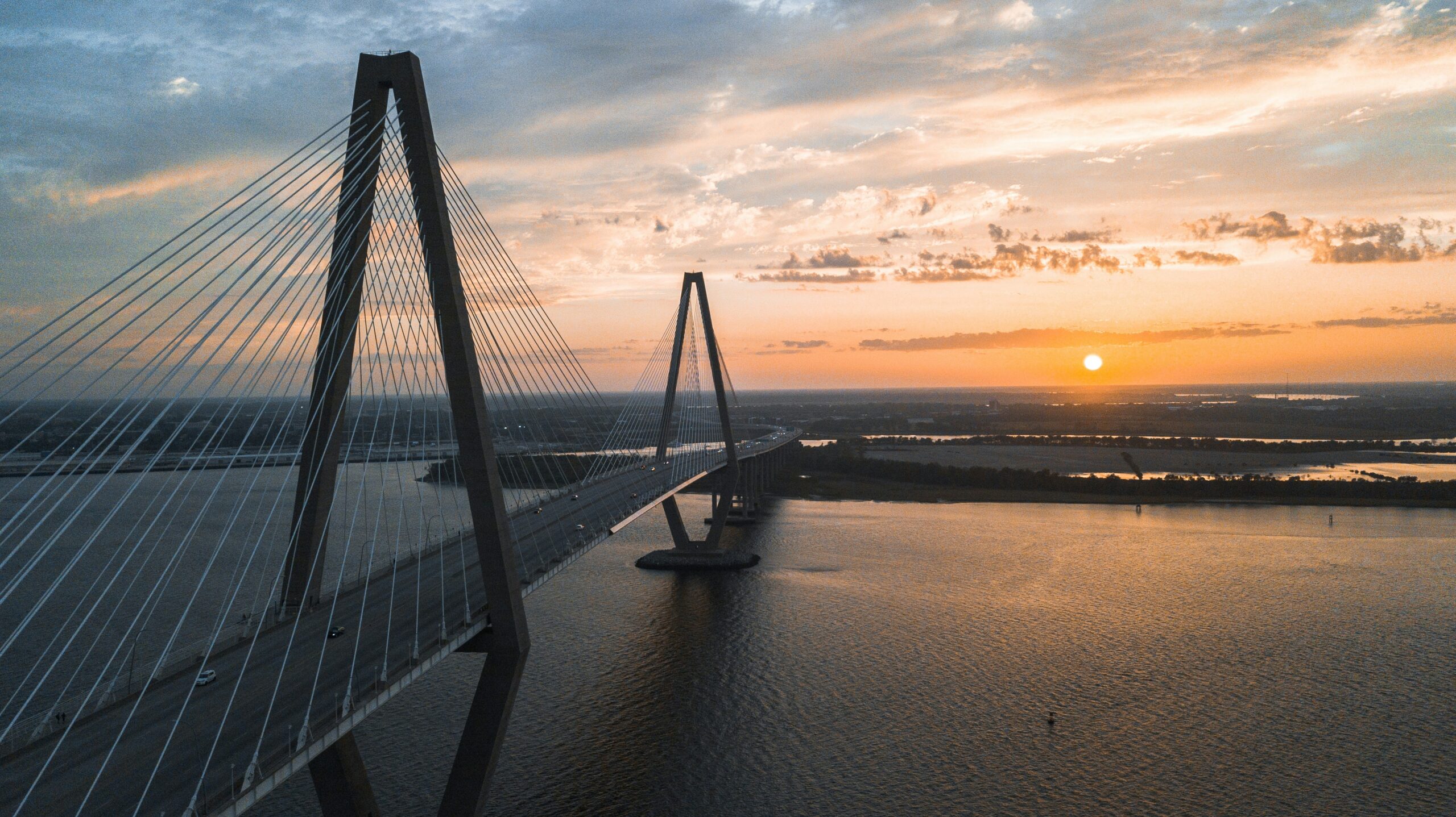 Charleston is one of the best places to live in South Carolina for beach fun, shopping and fine dining. Pictured: An aerial view of a bridge in Charleston