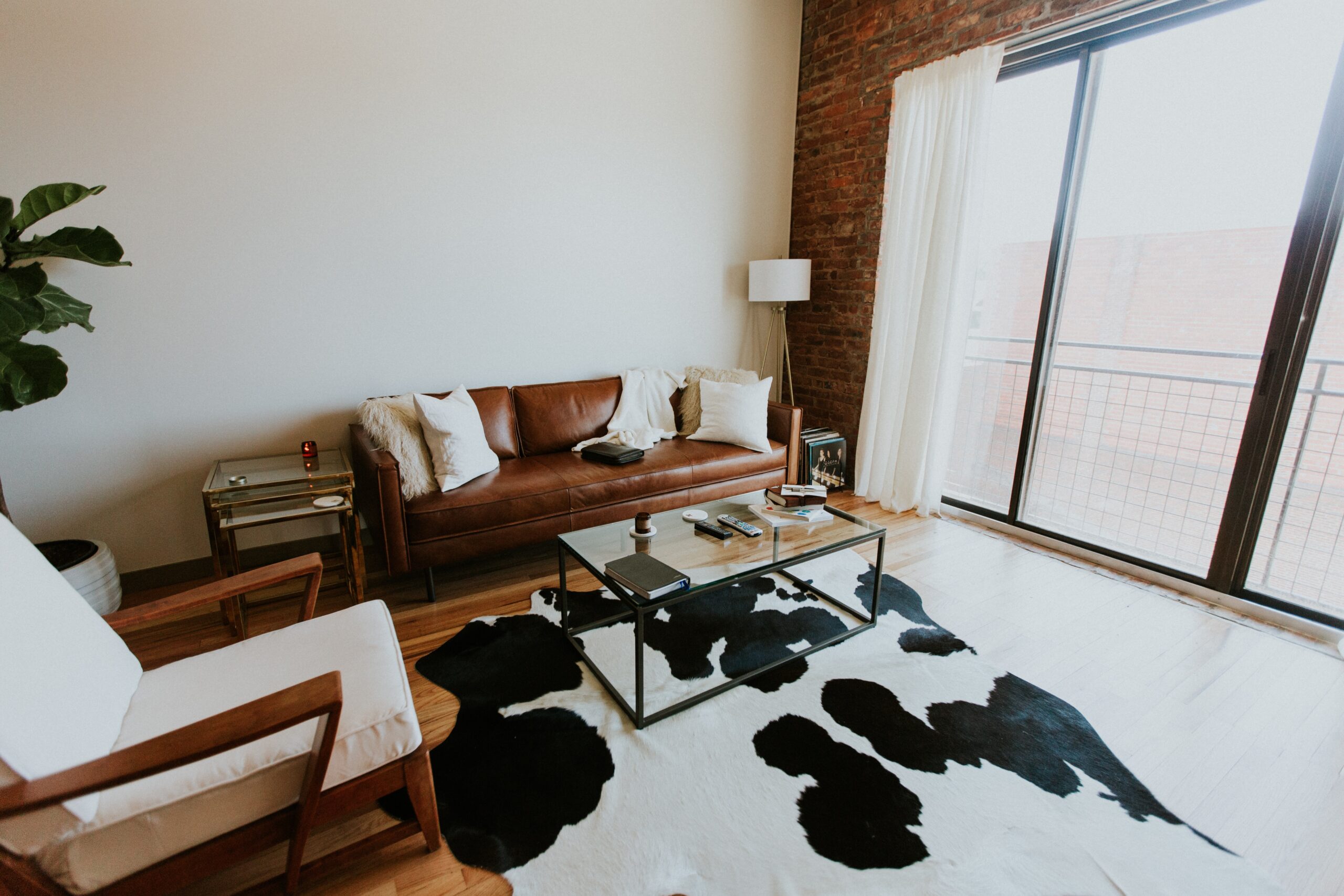 While you can learn how to clean a leather couch with this guide, contact a professional for tough stains that won't come out. Pictured: A living room