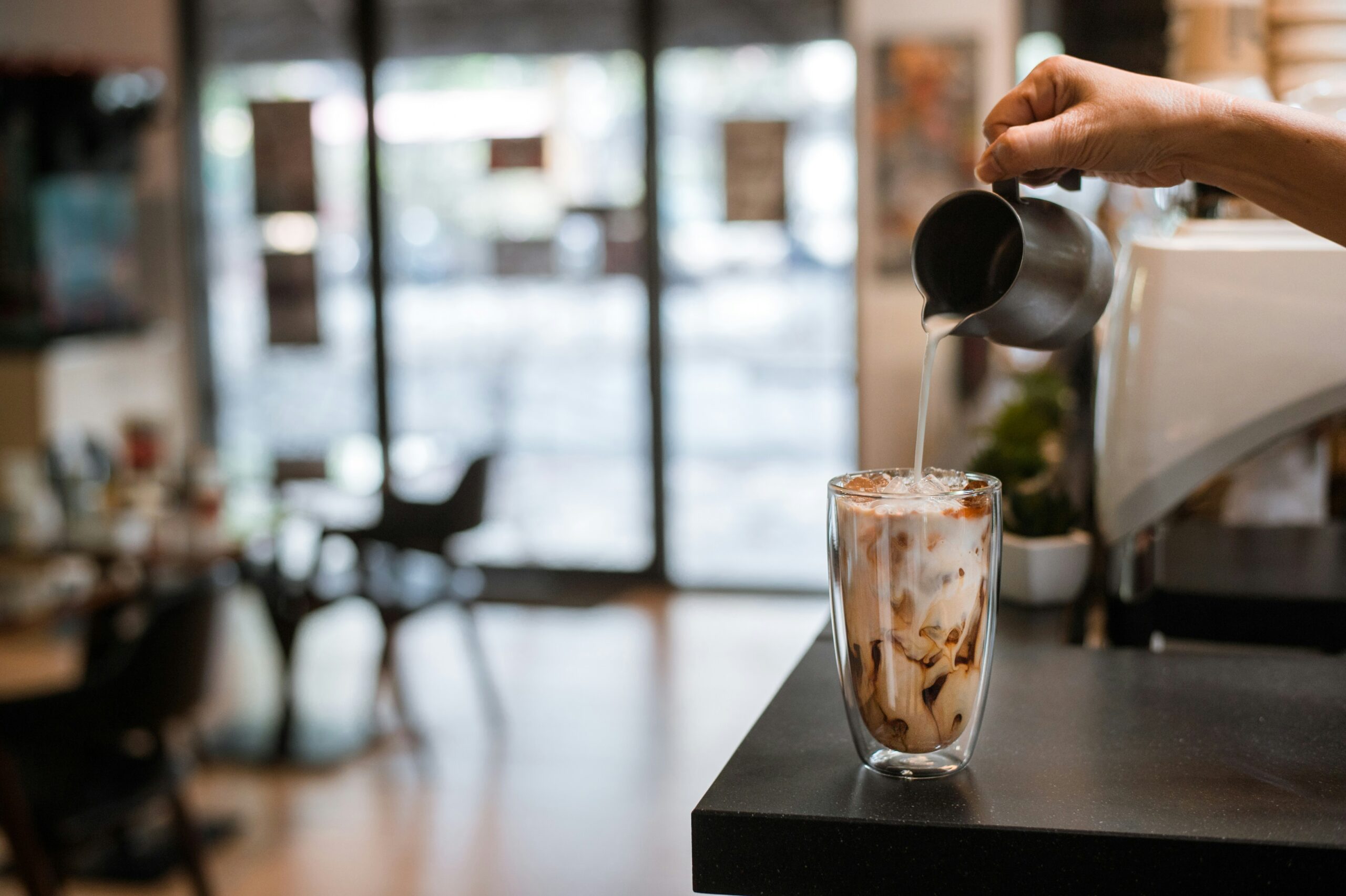 The Saint Helena Coffee is priced at over $330 a pound, making it one of the most expensive coffee brands. Pictured: Someone making iced coffee. 